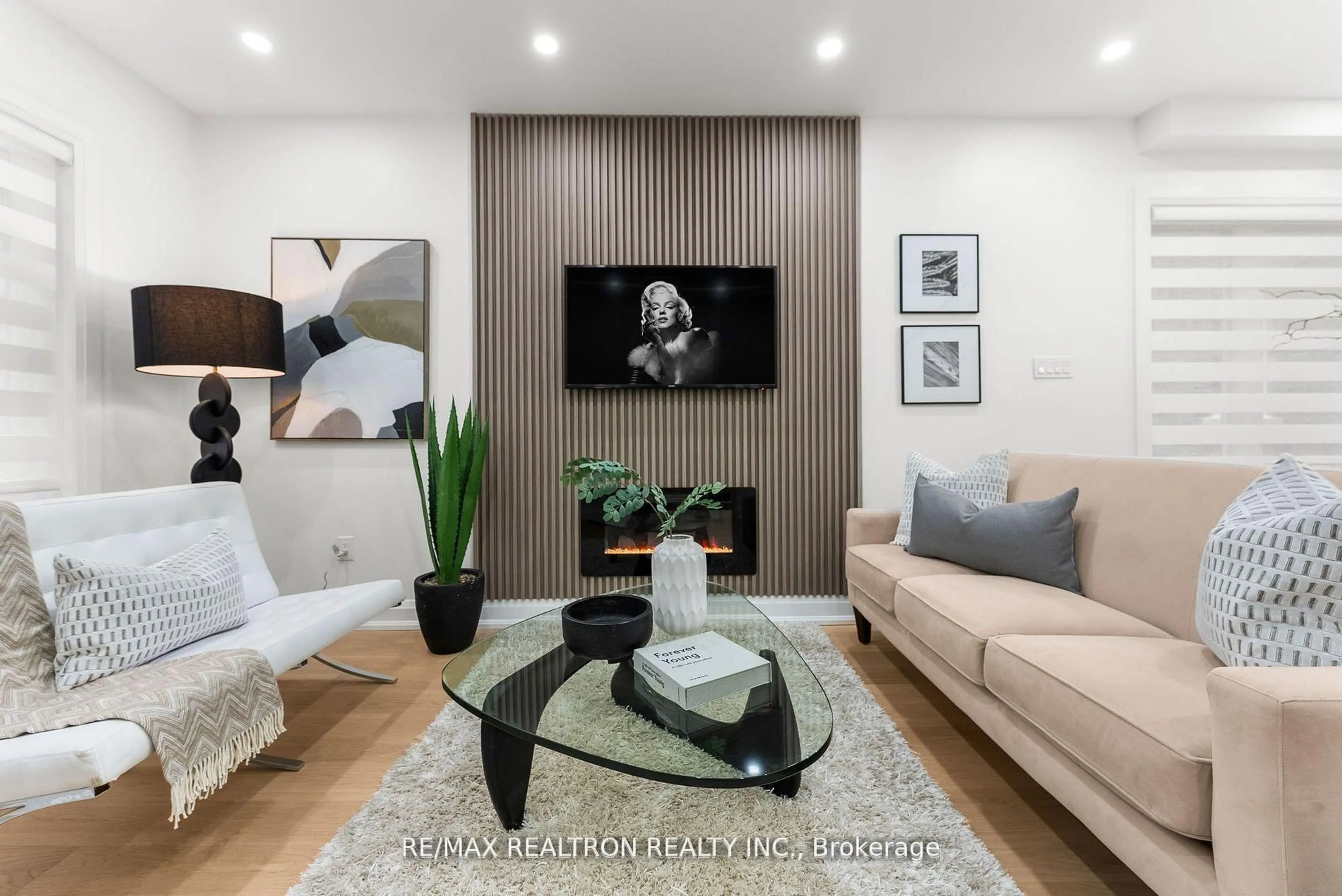 Living room with furniture, wood/laminate floor for 111 Glenmore Rd, Toronto Ontario M4L 3M2