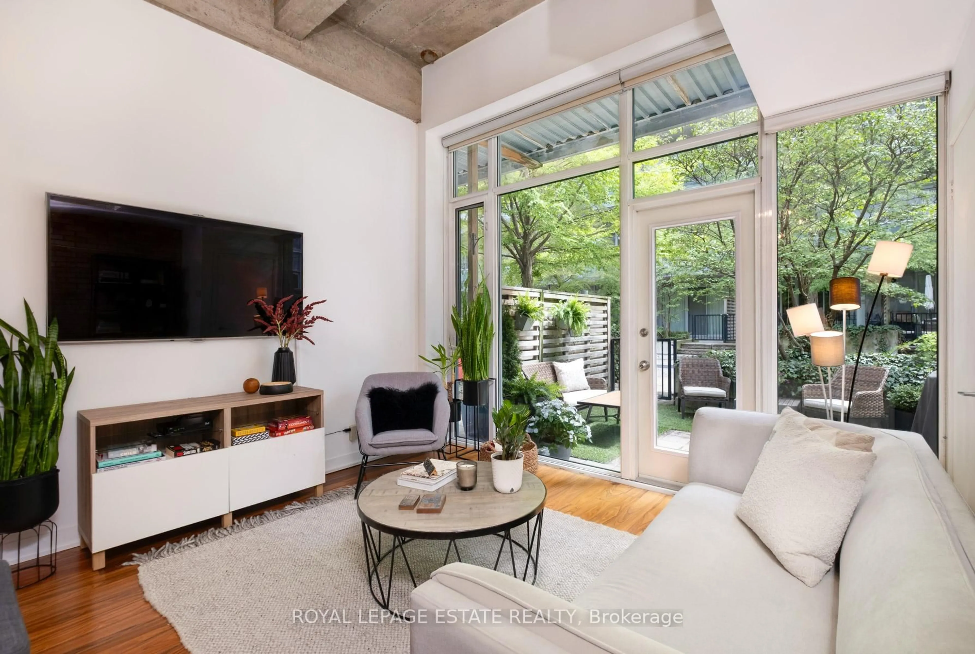 Living room with furniture, cement floor for 201 Carlaw Ave #142, Toronto Ontario M4M 2S3