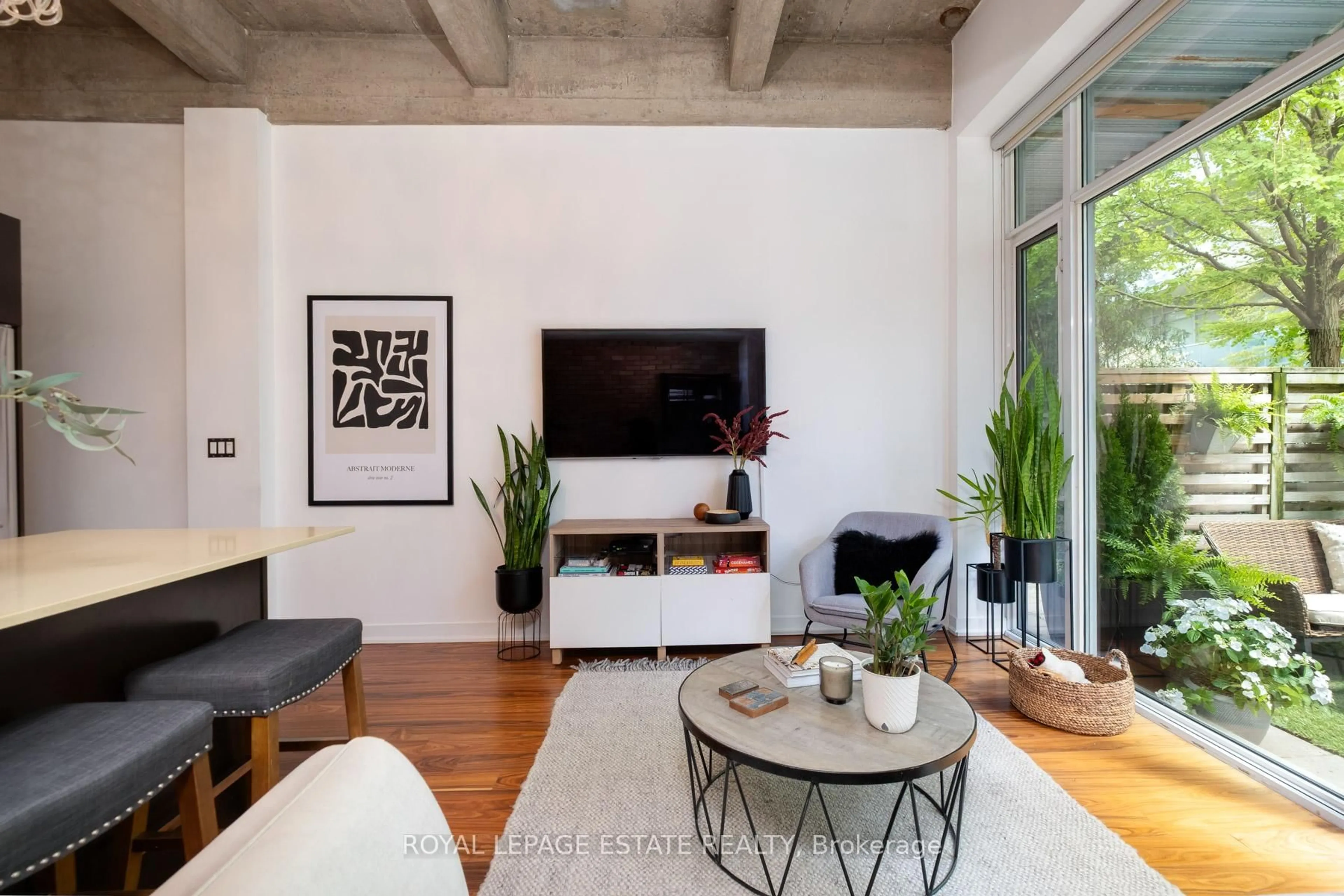 Living room with furniture, cement floor for 201 Carlaw Ave #142, Toronto Ontario M4M 2S3