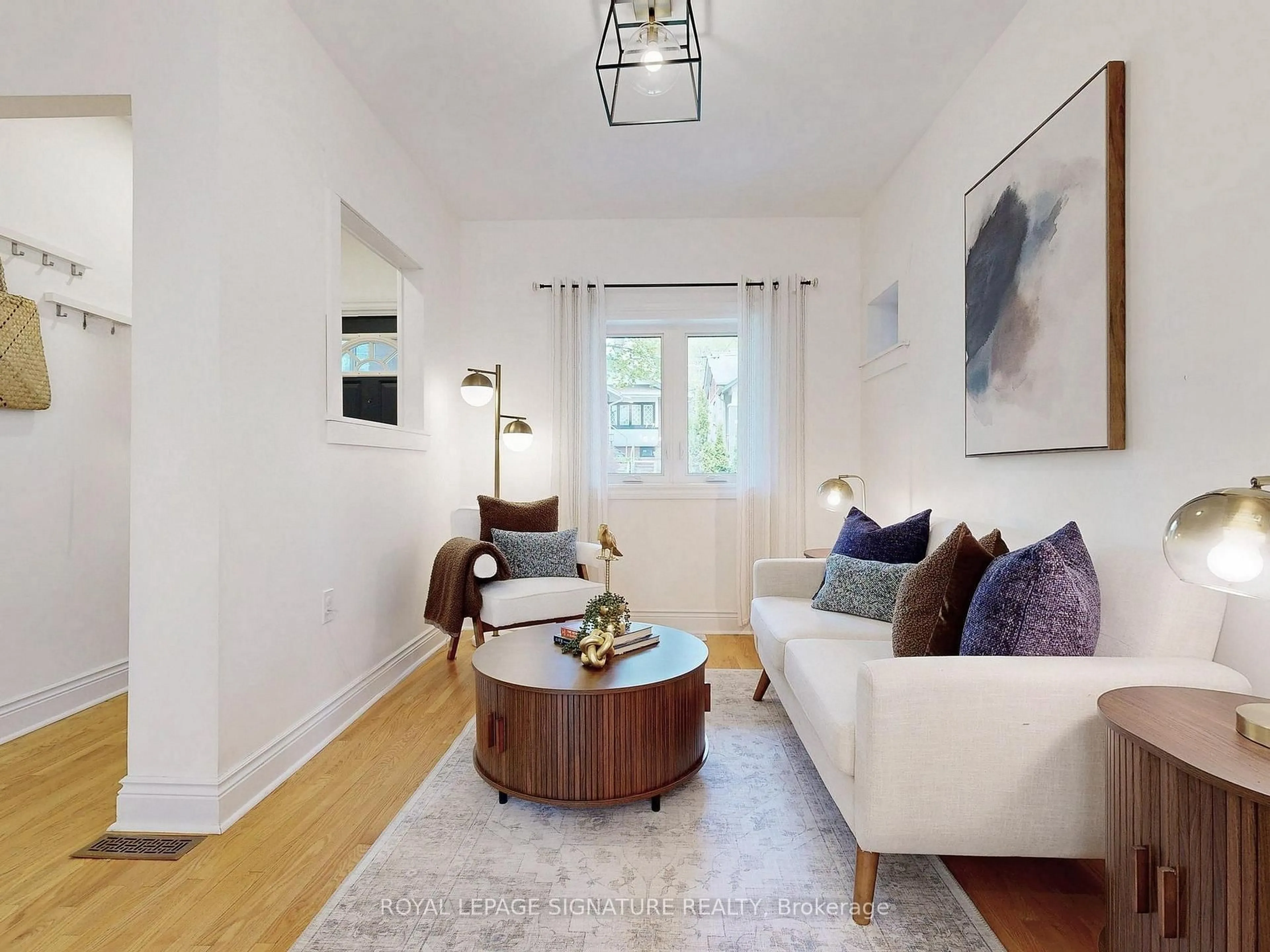 Living room with furniture, wood/laminate floor for 117 Burgess Ave, Toronto Ontario M4E 1X3