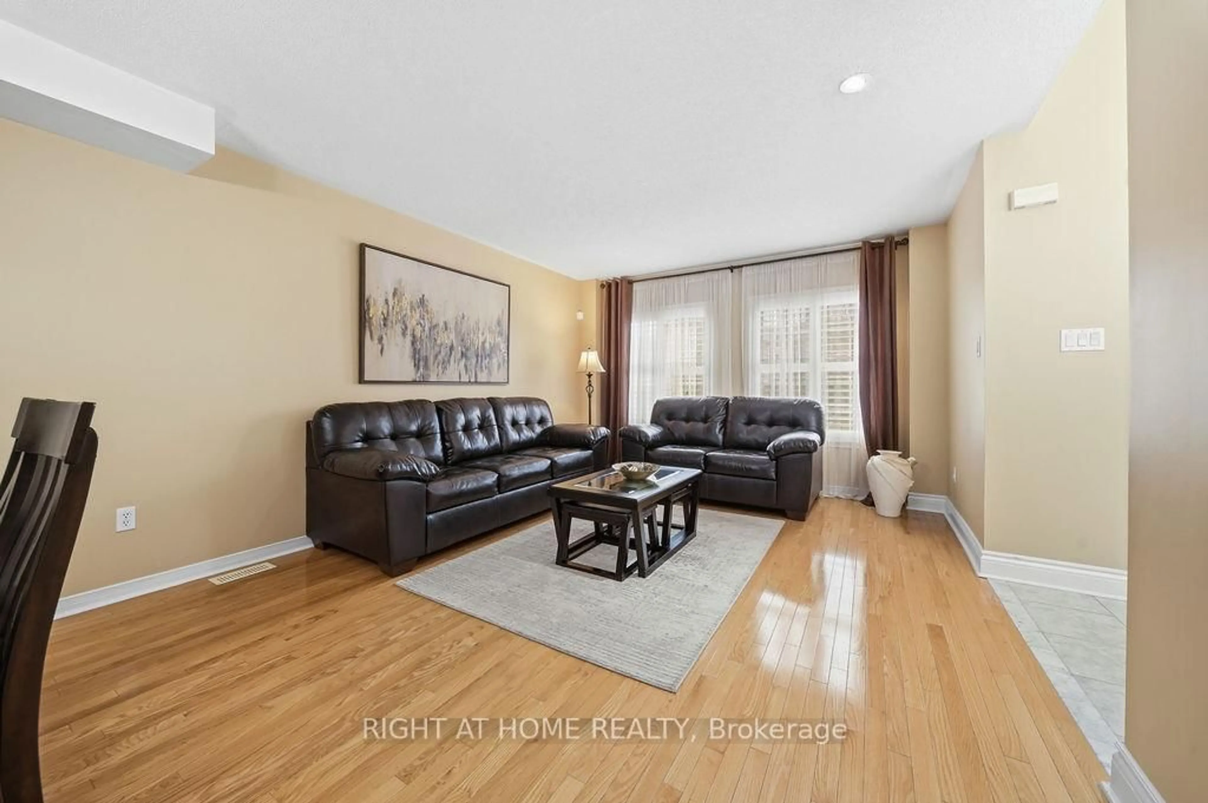 Living room with furniture, wood/laminate floor for 25 Nobbs Dr, Ajax Ontario L1T 4M1