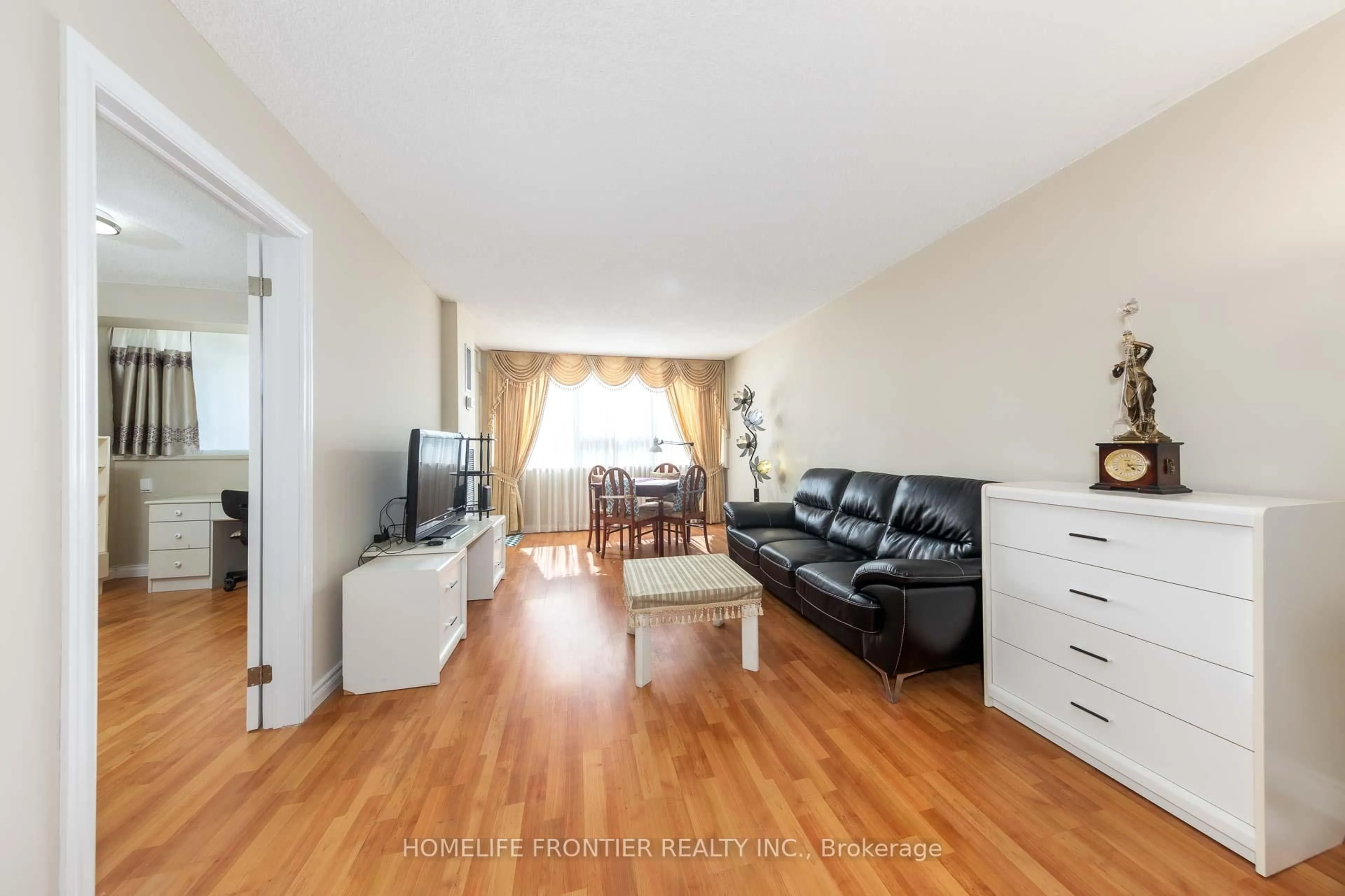 Living room with furniture, wood/laminate floor for 45 Silver Springs Blvd #706, Toronto Ontario M1V 1R2