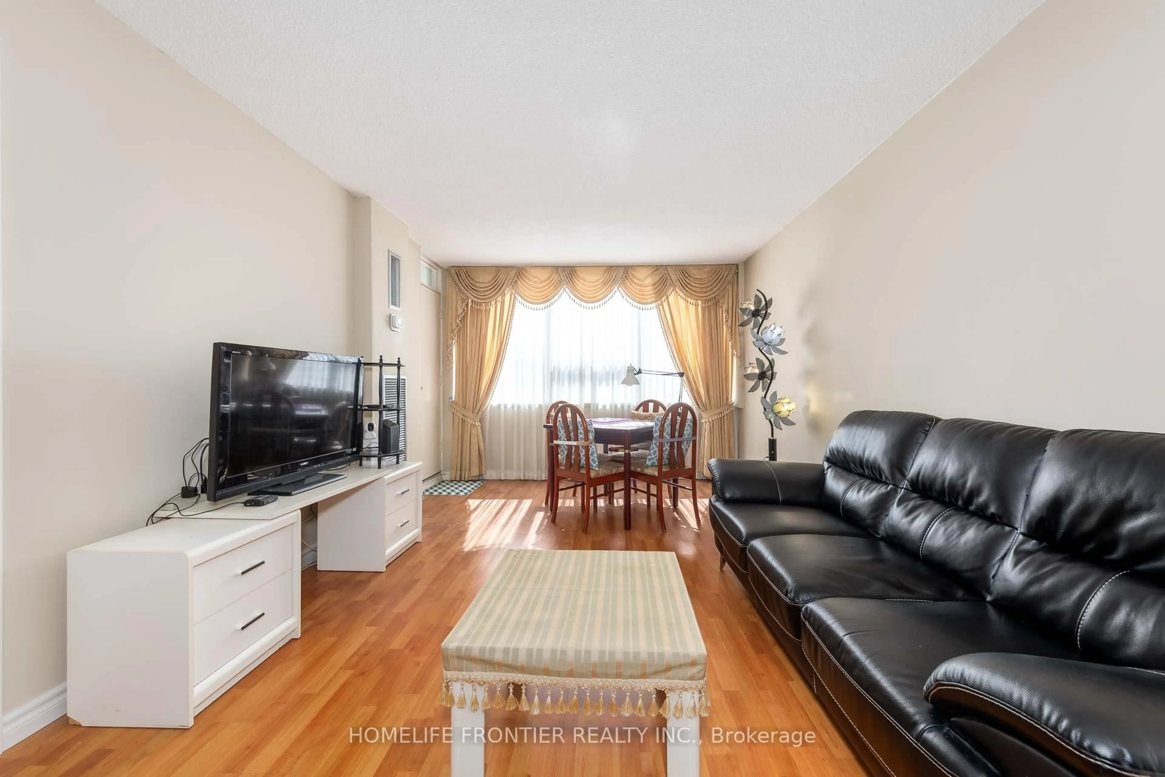 Living room with furniture, wood/laminate floor for 45 Silver Springs Blvd #706, Toronto Ontario M1V 1R2