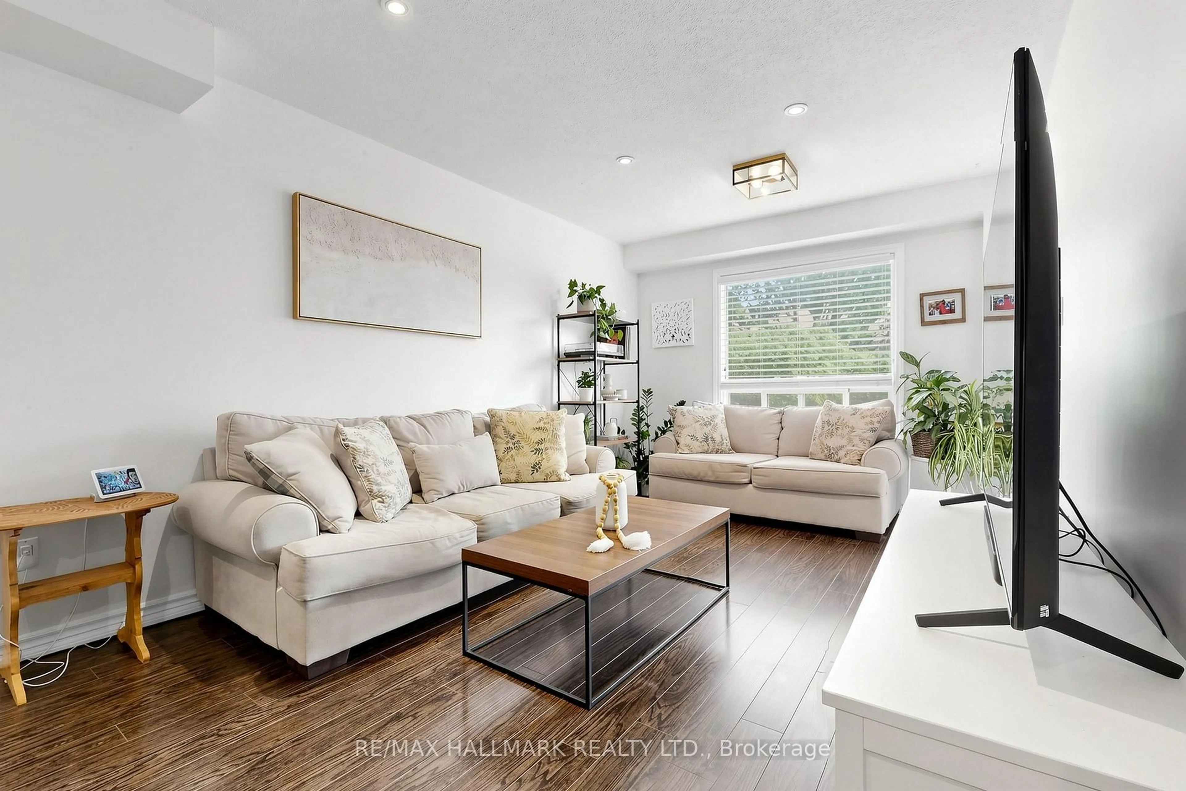 Living room with furniture, wood/laminate floor for 10 Bassett Blvd #189, Whitby Ontario L1N 9C7