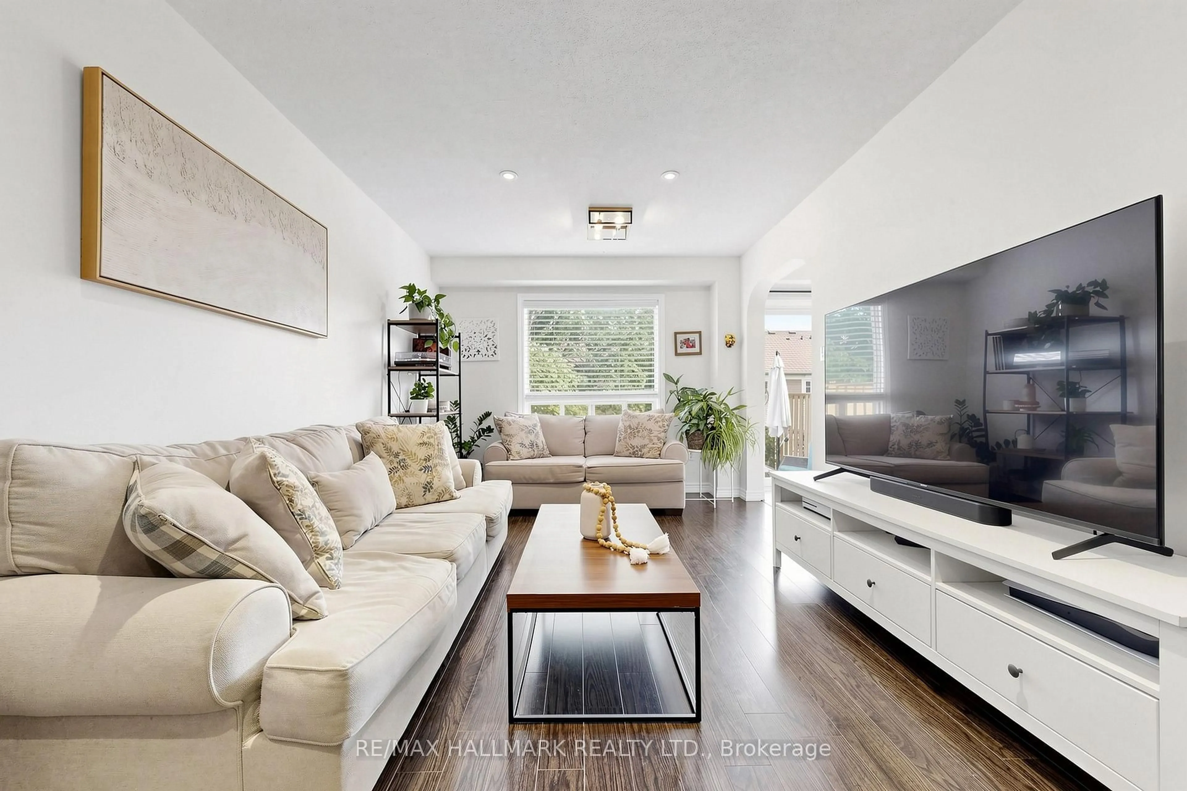 Living room with furniture, wood/laminate floor for 10 Bassett Blvd #189, Whitby Ontario L1N 9C7
