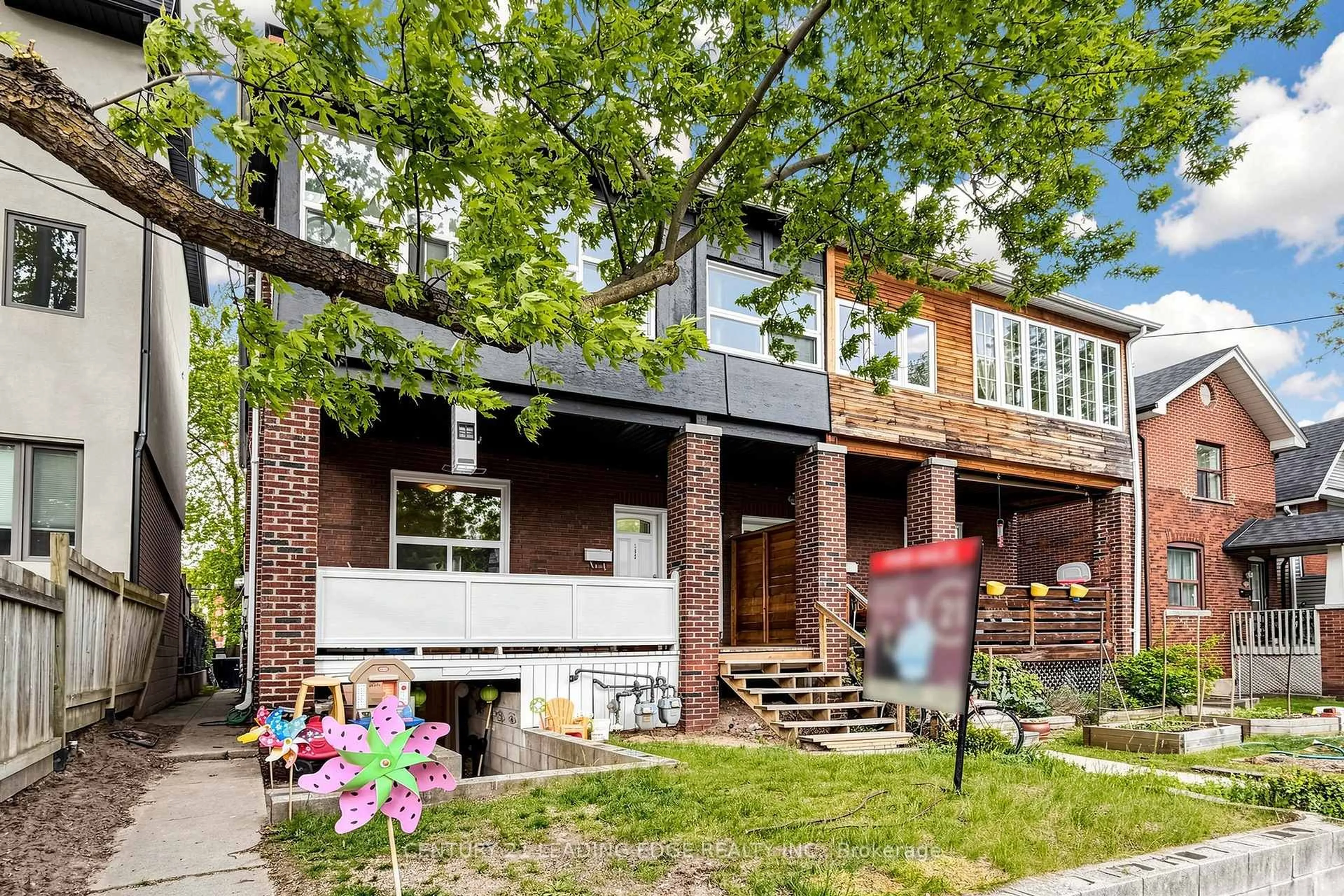 Home with brick exterior material, street for 395 Rhodes Ave, Toronto Ontario M4L 3A6