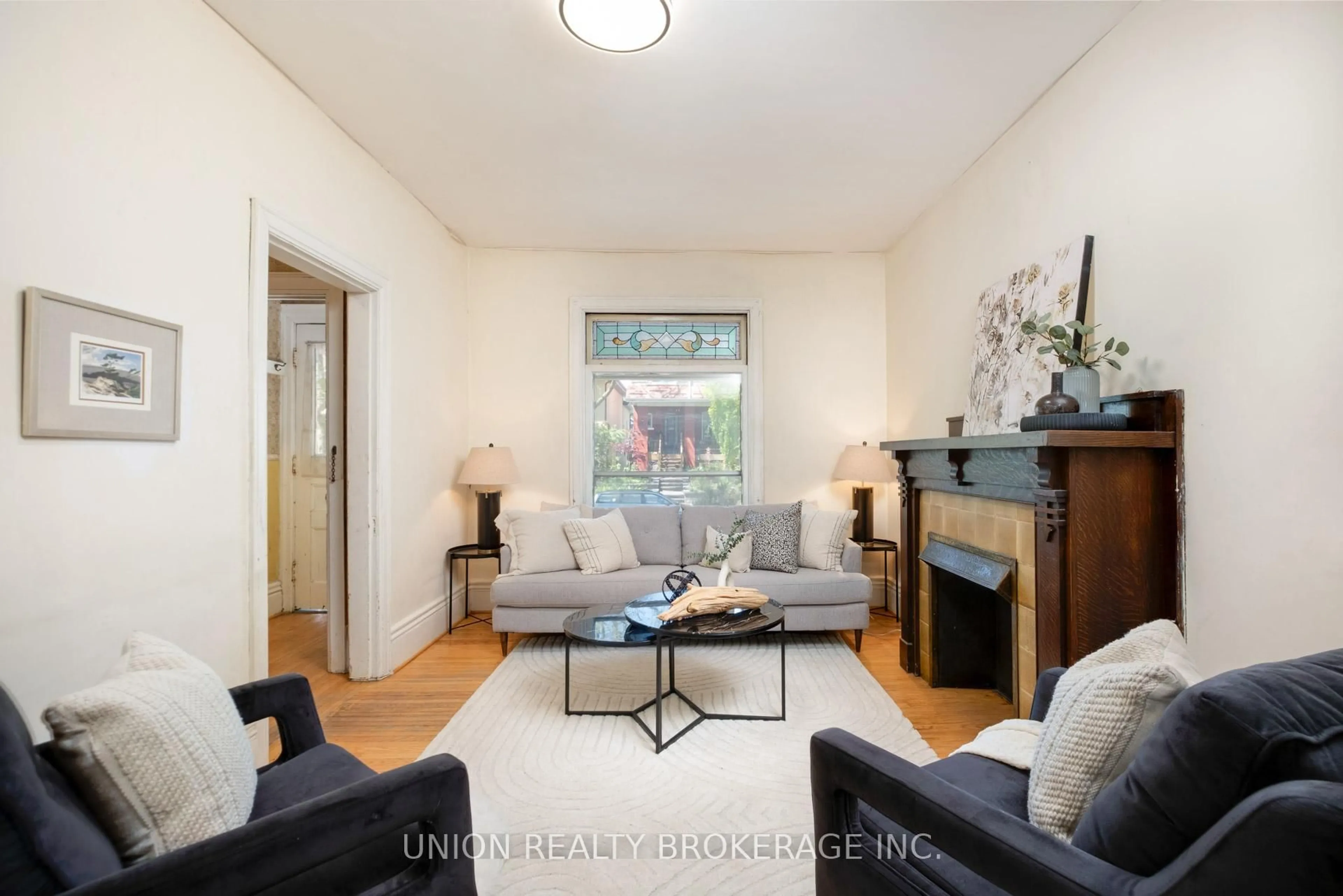 Living room with furniture, wood/laminate floor for 75 Redwood Ave, Toronto Ontario M4L 2S5