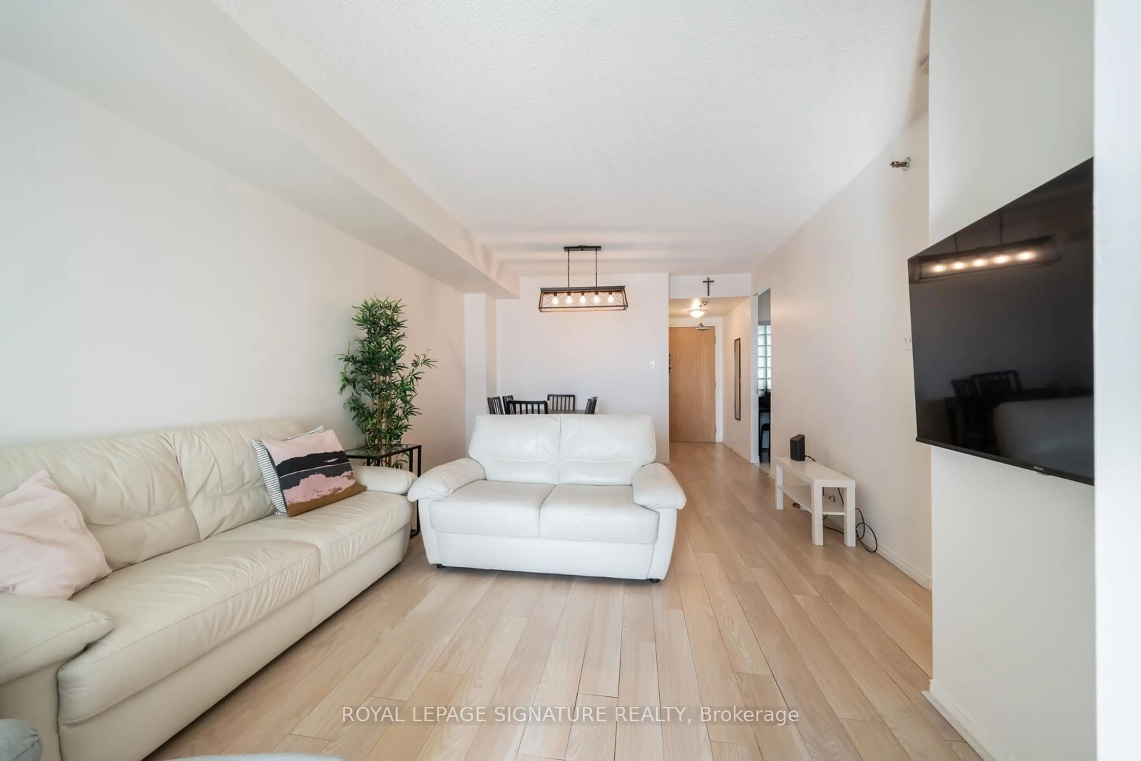Living room with furniture, wood/laminate floor for 5800 Sheppard Ave #316, Toronto Ontario M1B 5J7