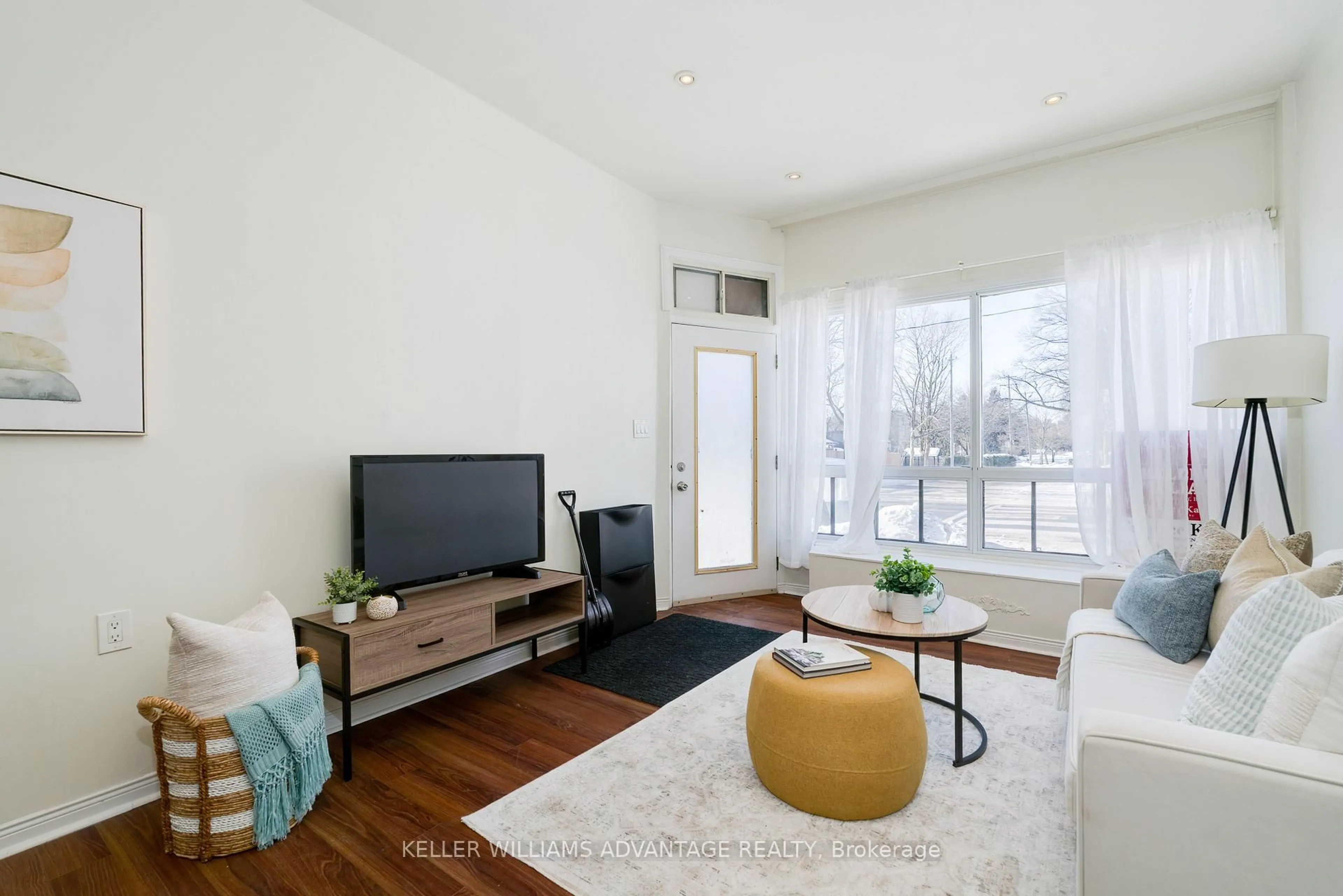 Living room with furniture, wood/laminate floor for 493 Jones Ave, Toronto Ontario M4J 3G8