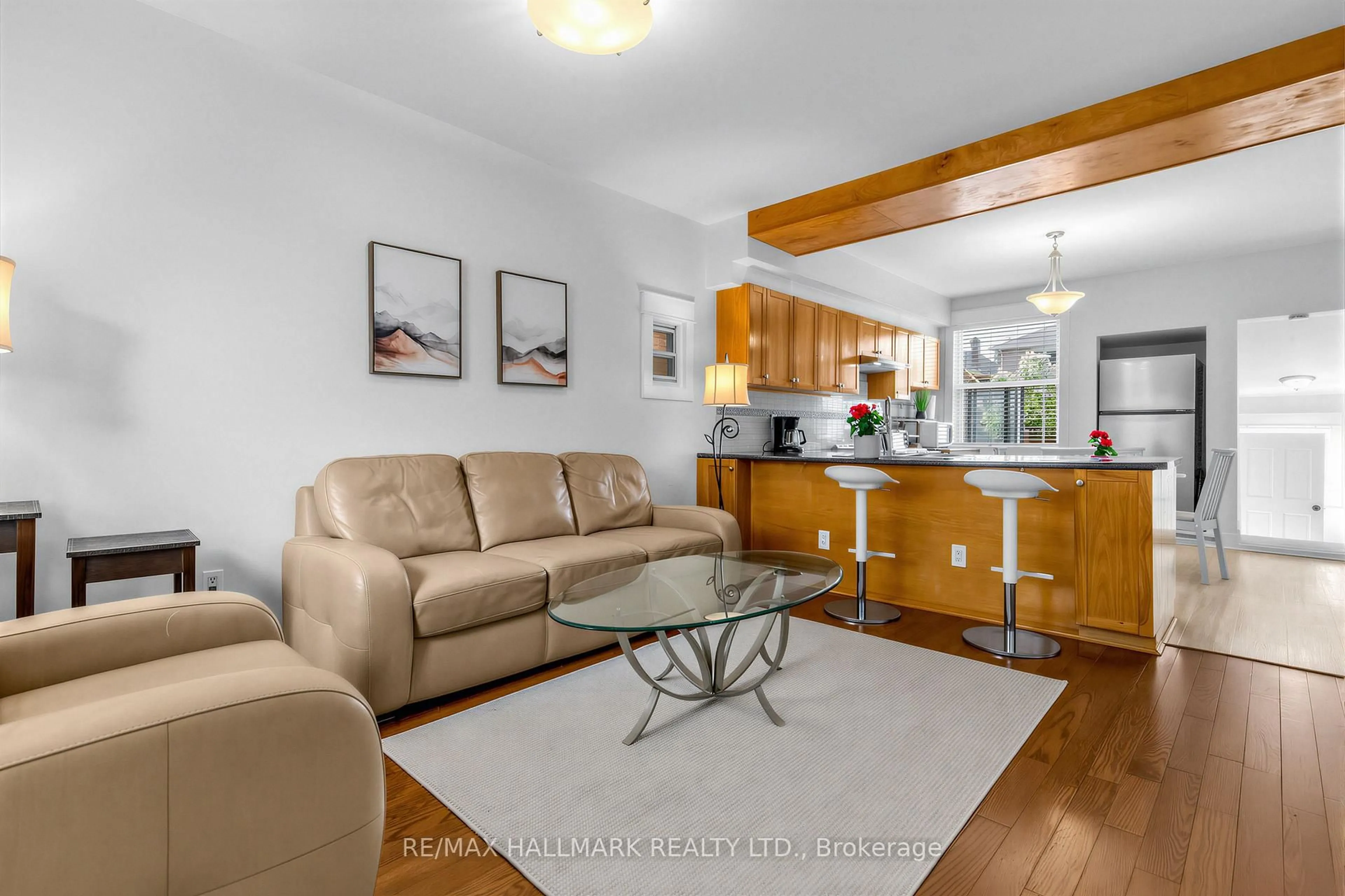 Living room with furniture, wood/laminate floor for 65 Wallington Ave, Toronto Ontario M4C 2N2