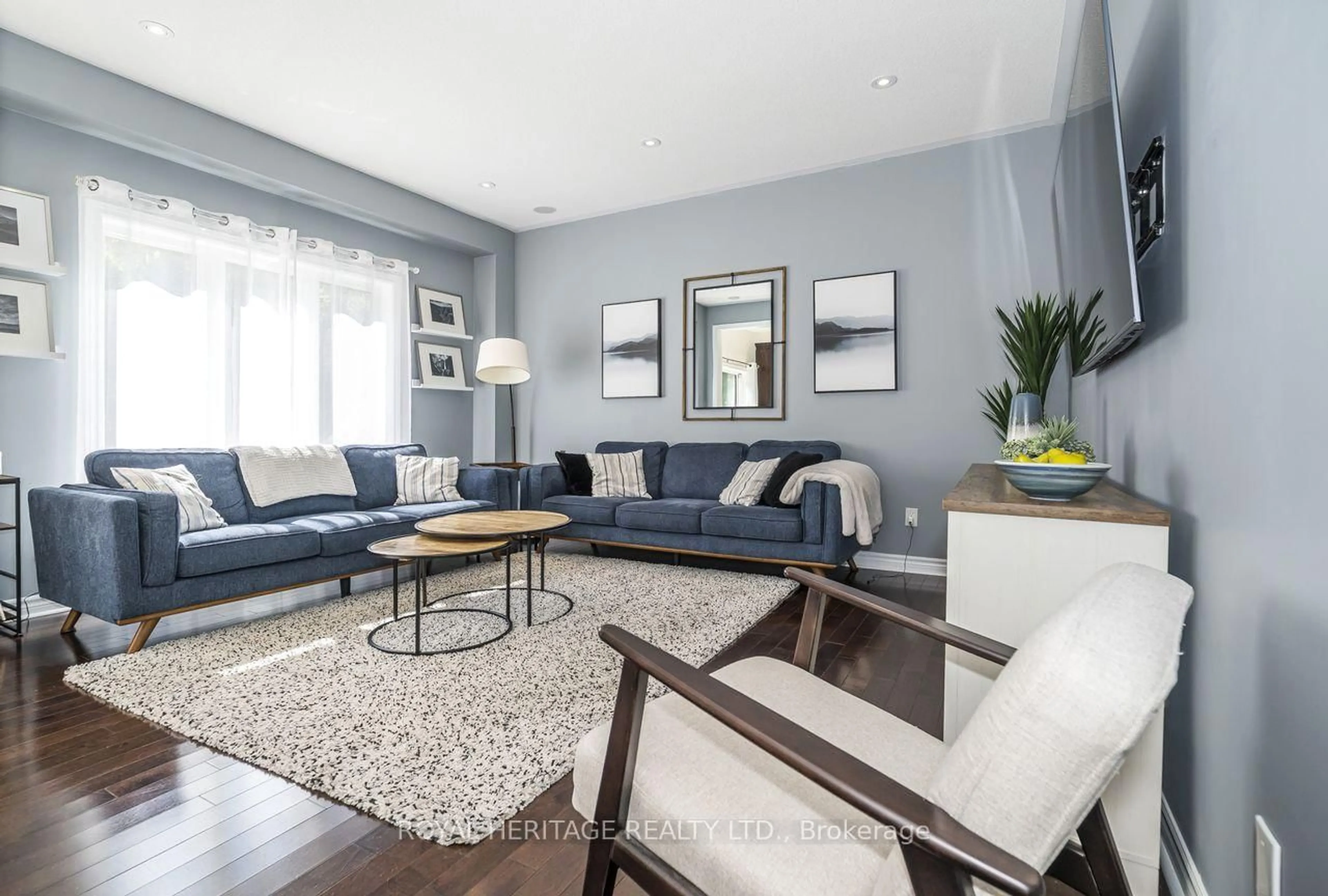 Living room with furniture, wood/laminate floor for 64 Florence Dr, Whitby Ontario L1R 0K3
