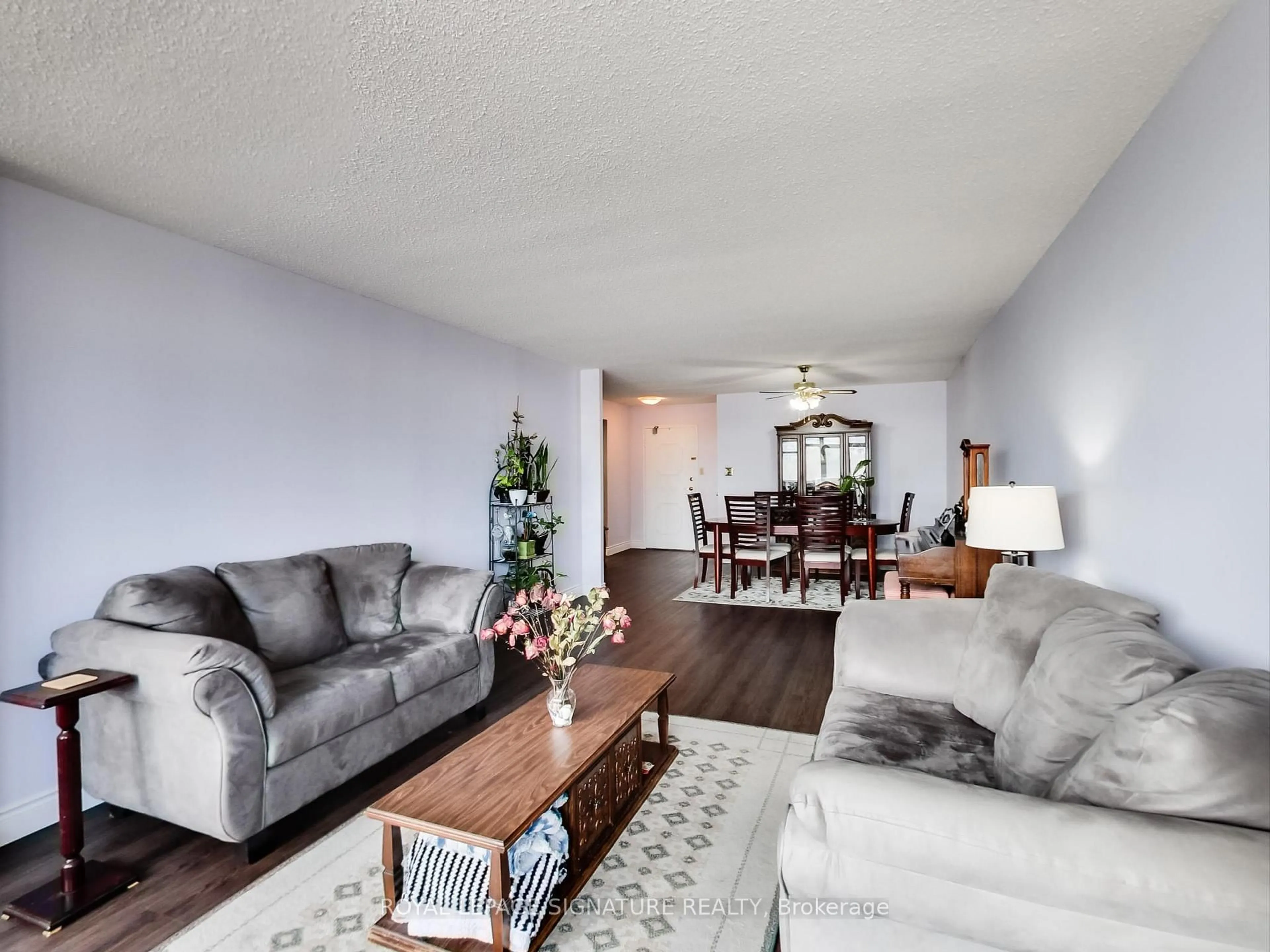 Living room with furniture, wood/laminate floor for 3151 Bridletowne Circ #506, Toronto Ontario M1W 2T1