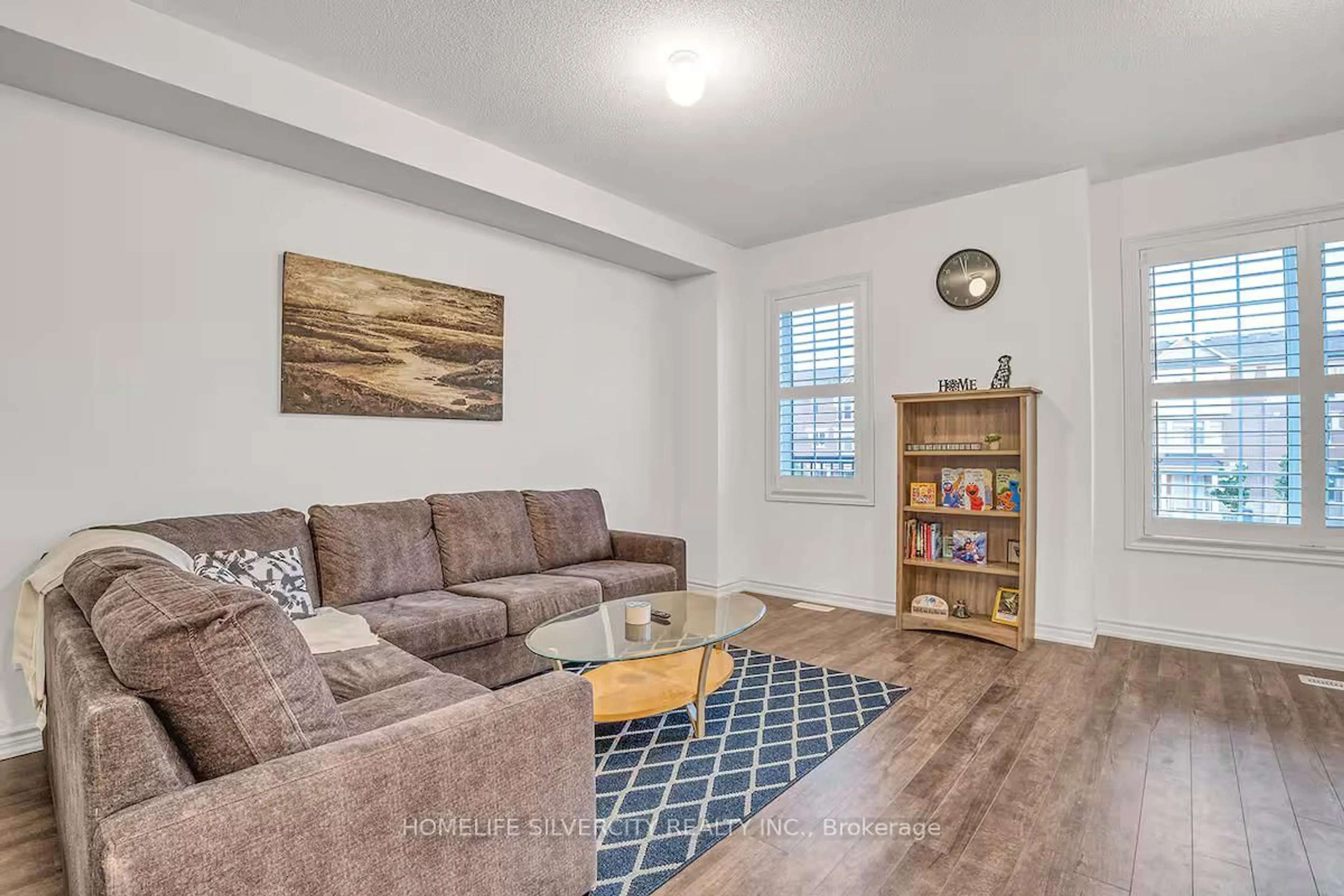 Living room with furniture, wood/laminate floor for 43 Honey Crisp Lane, Clarington Ontario L1C 7H7