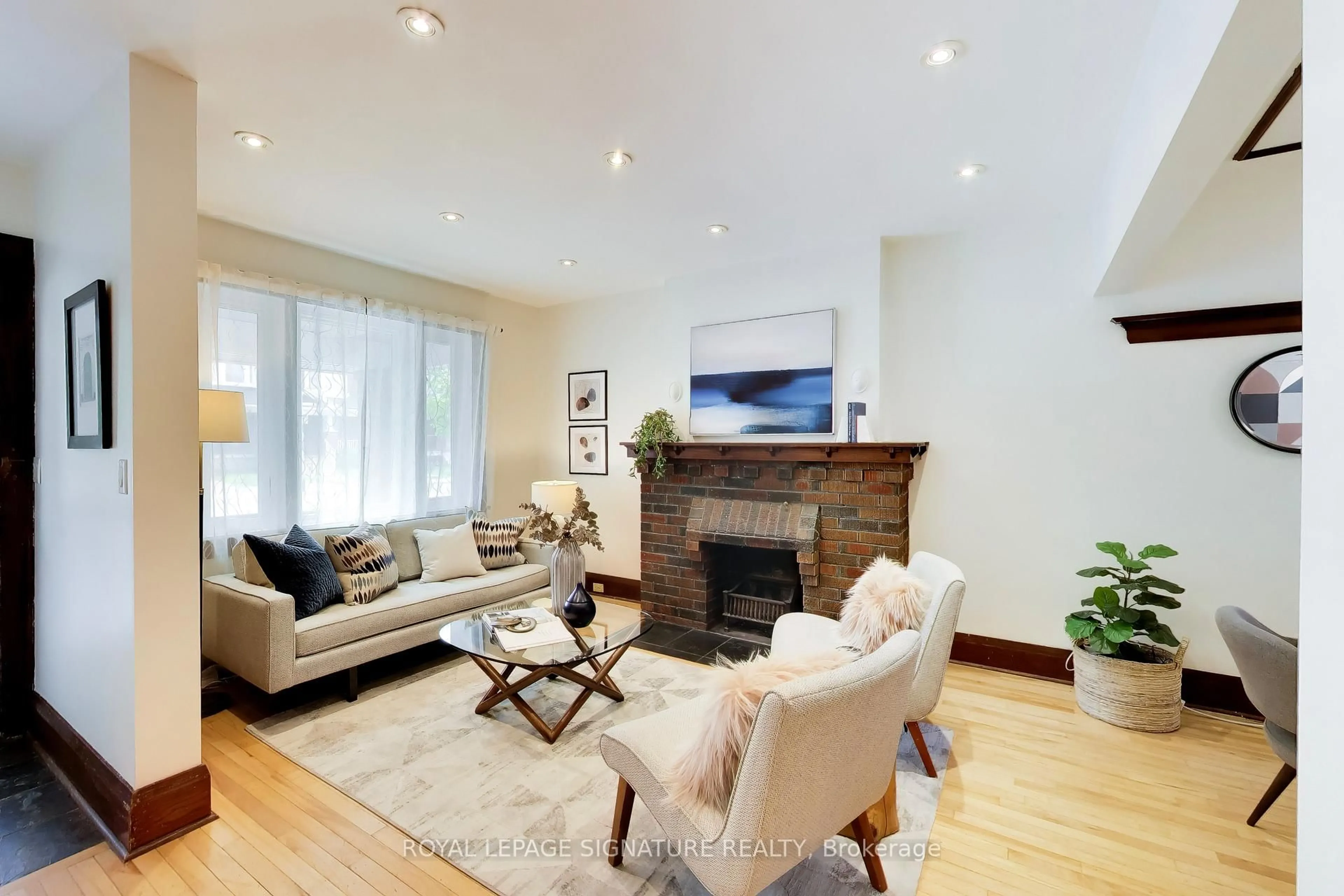 Living room with furniture, wood/laminate floor for 2102 Gerrard St, Toronto Ontario M4E 2B8