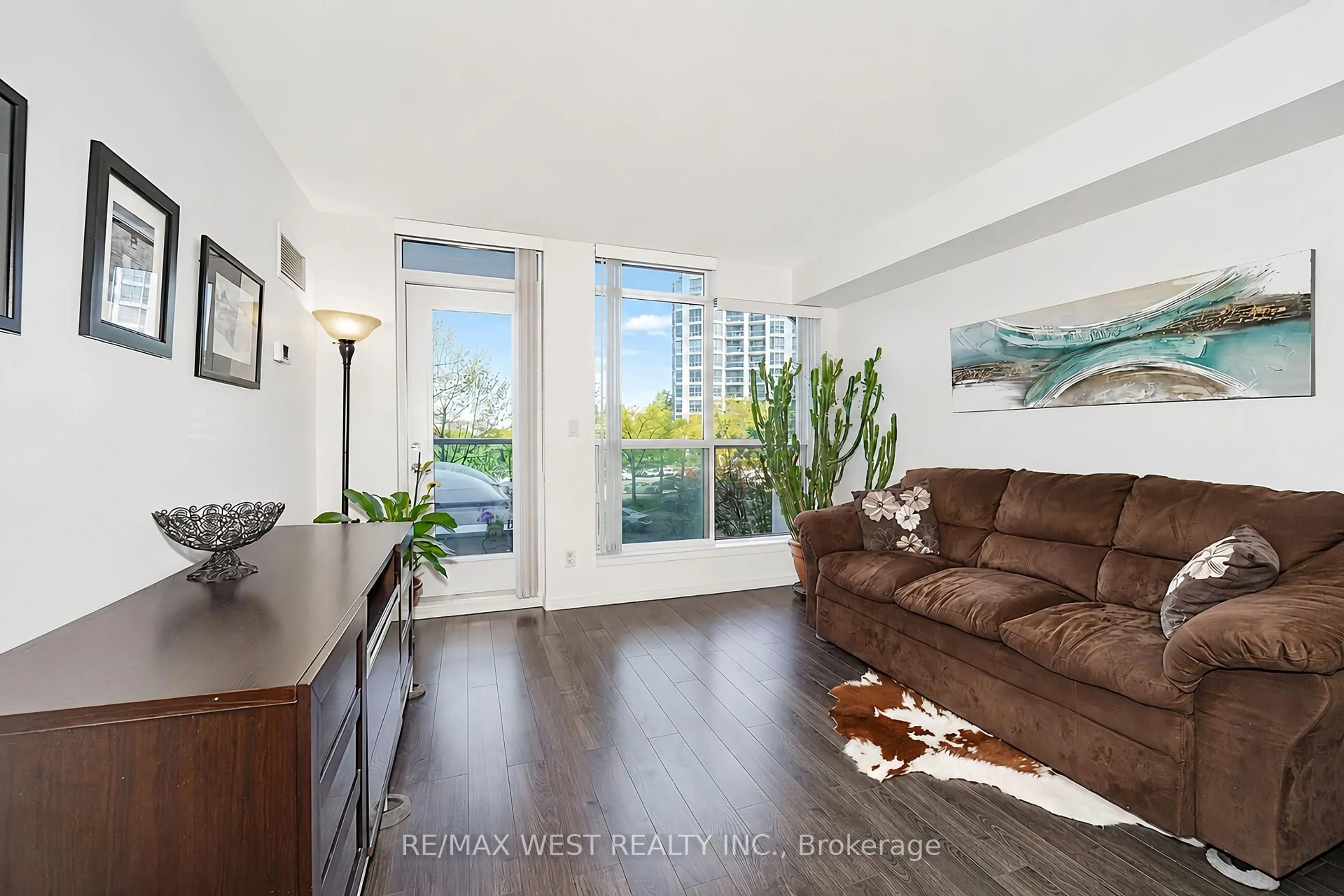 Living room with furniture, wood/laminate floor for 340 Watson St #216, Whitby Ontario L1N 9G1