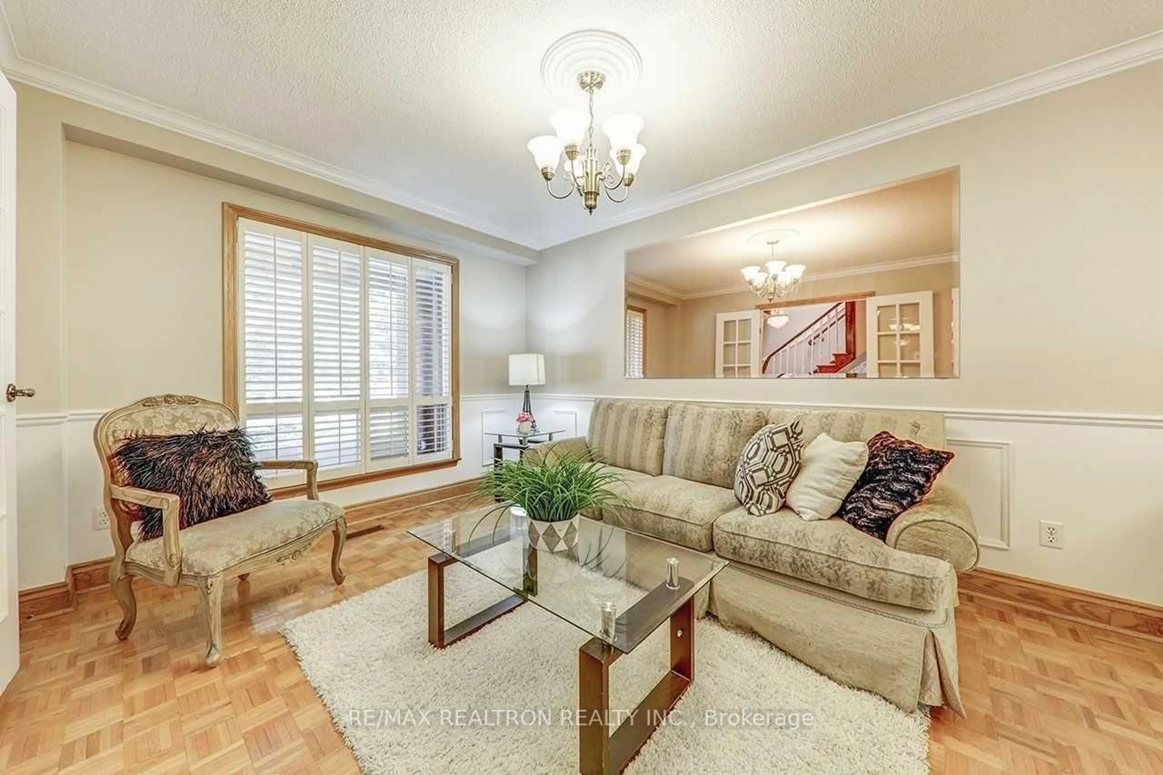 Living room with furniture, wood/laminate floor for 117 Dunsfold Dr, Toronto Ontario M1B 1T5