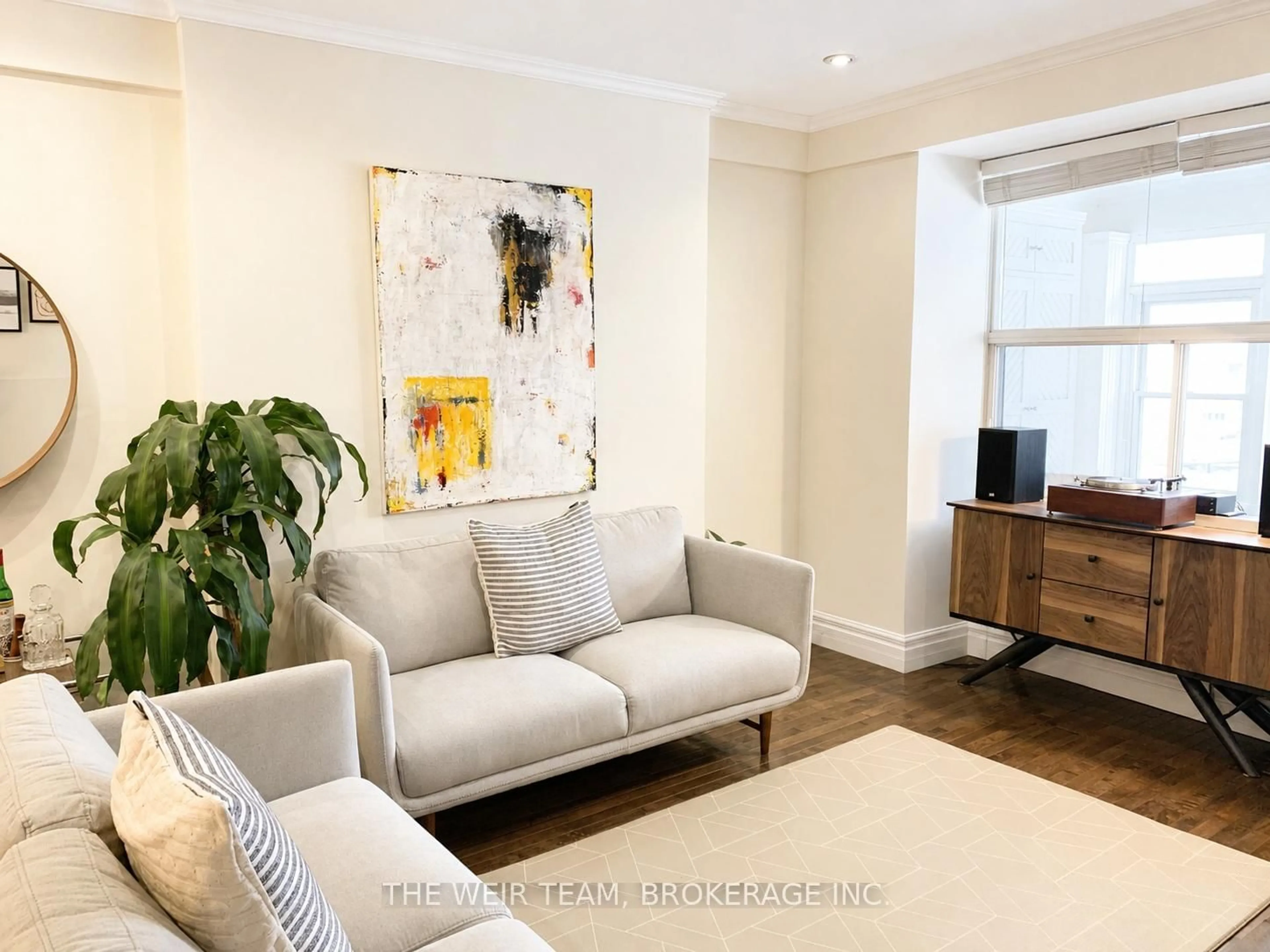 Living room with furniture, wood/laminate floor for 911 Woodbine Ave, Toronto Ontario M4C 4B6
