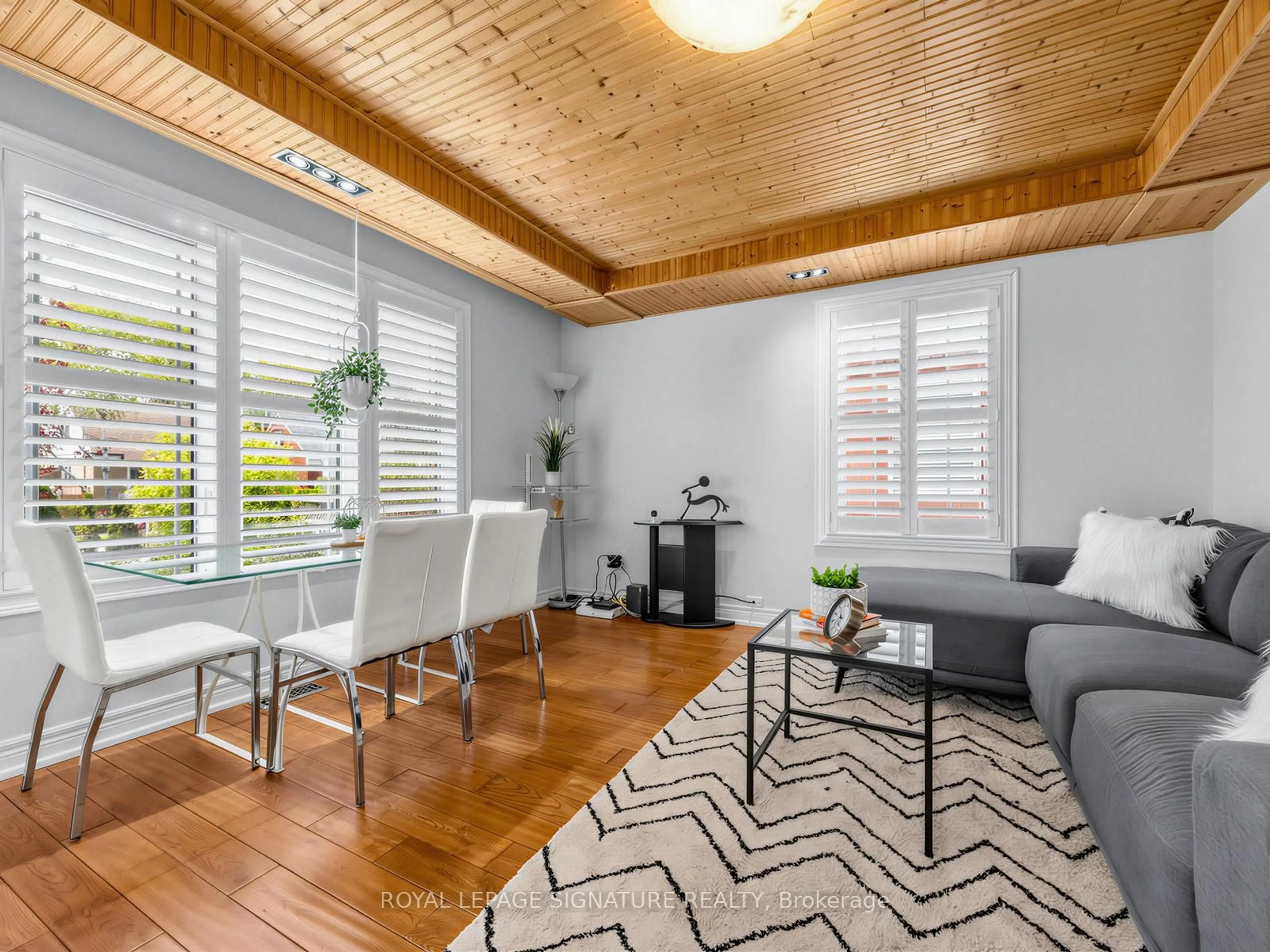 Living room with furniture, wood/laminate floor for 67 Ellington Dr, Toronto Ontario M1R 3Y2