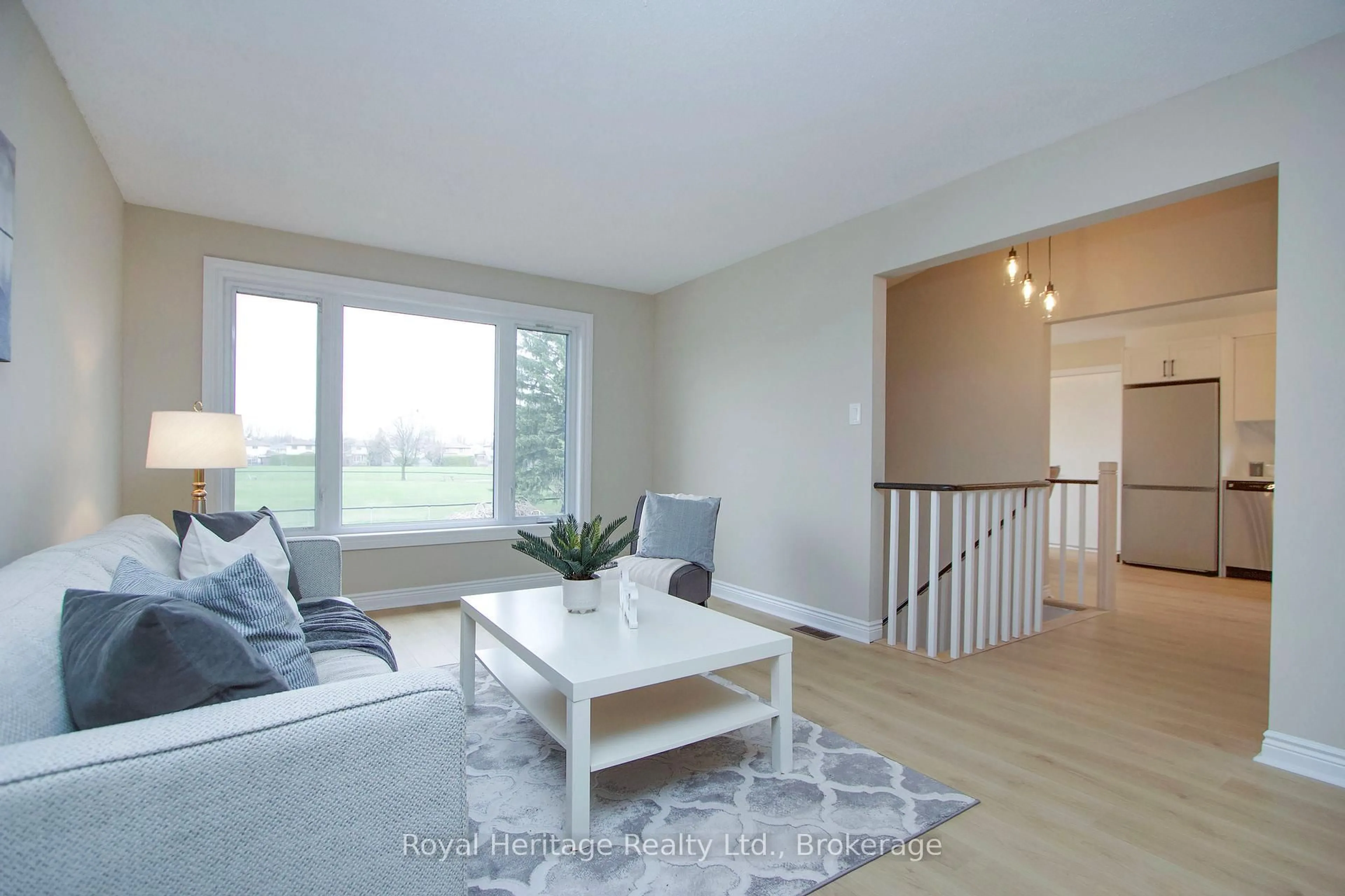 Living room with furniture, wood/laminate floor for 77 Devondale St, Clarington Ontario L1E 2A1