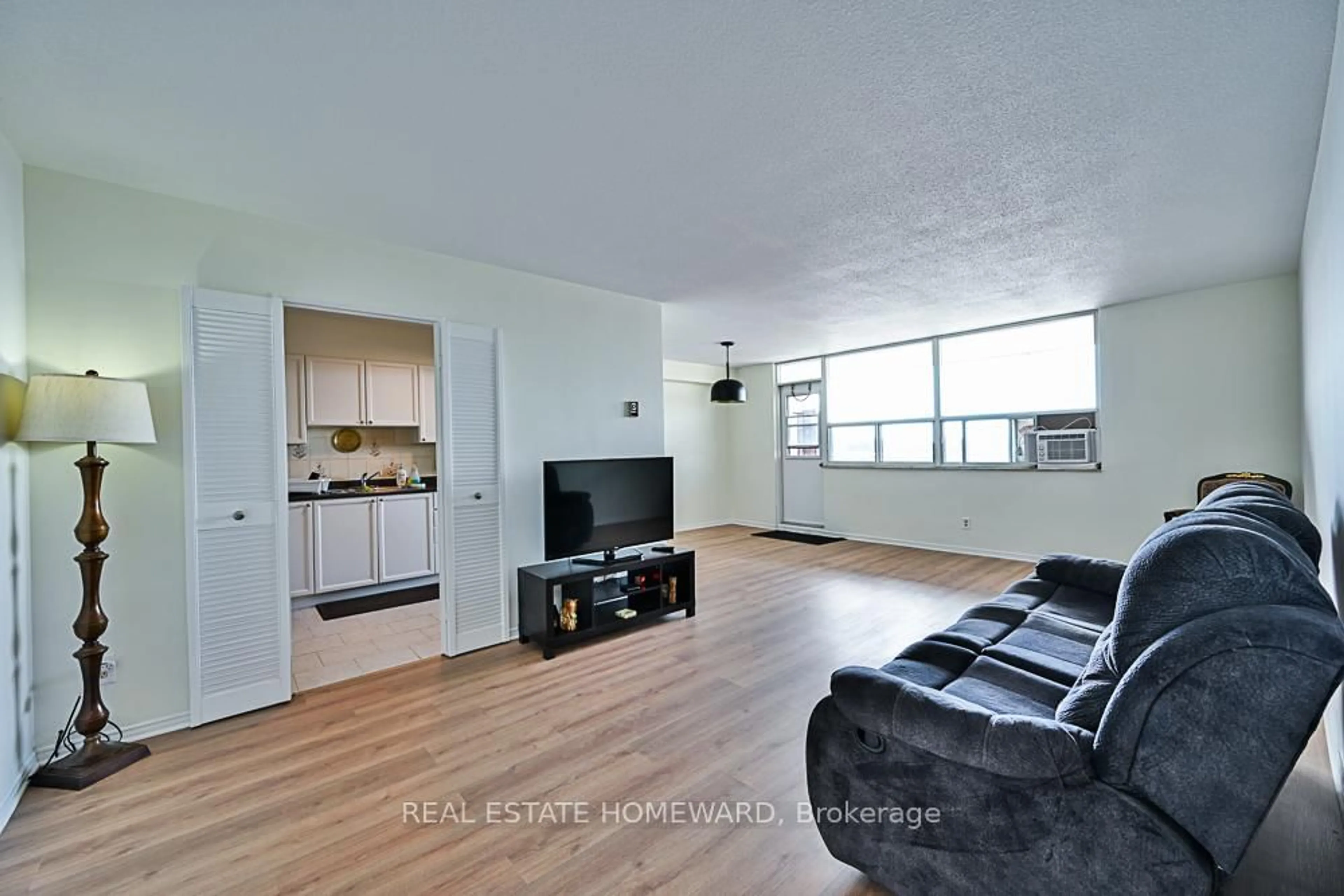 Living room with furniture, wood/laminate floor for 2550 Pharmacy Ave #1015, Toronto Ontario M1W 1H9