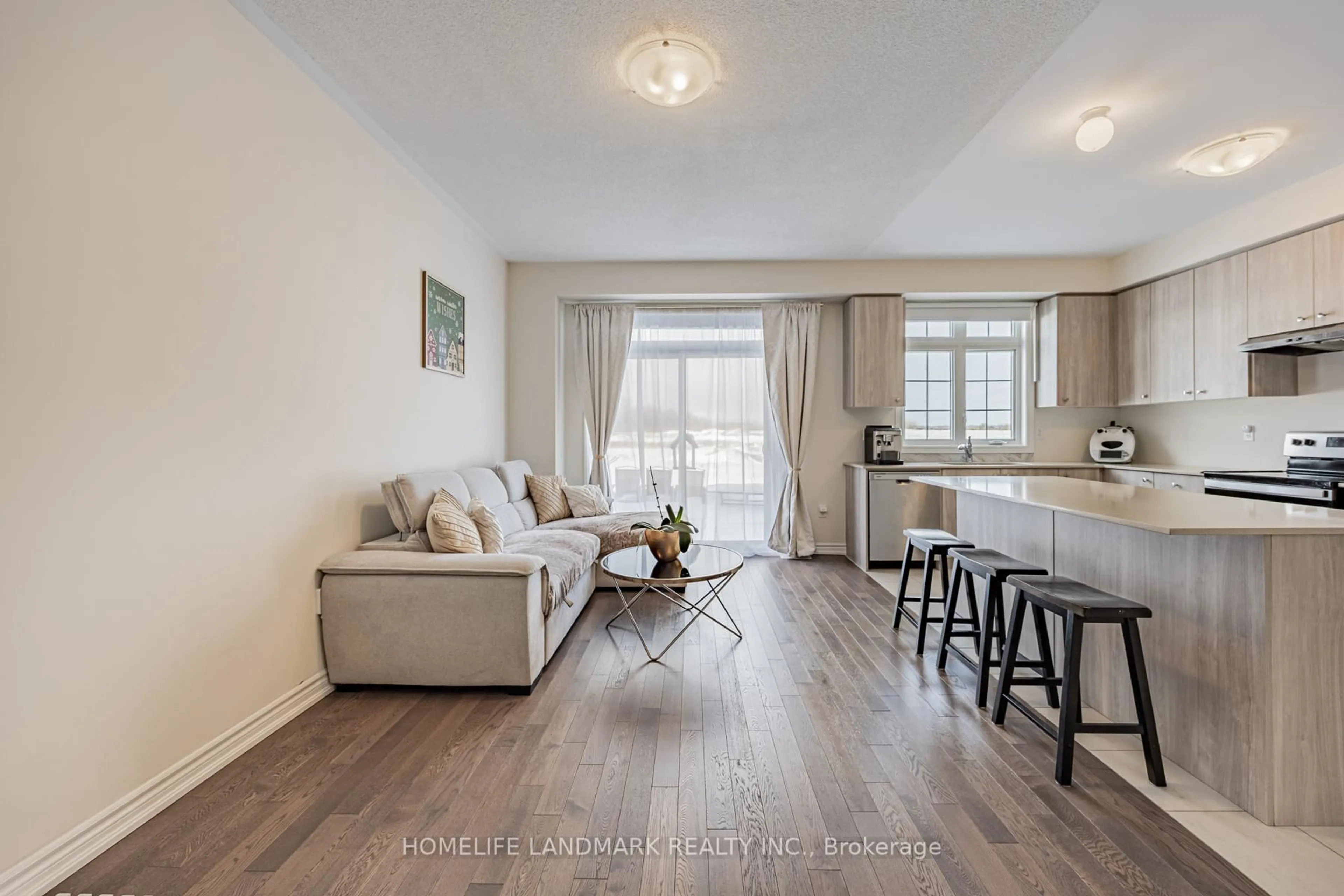Living room with furniture, wood/laminate floor for 1102 Pisces Tr, Pickering Ontario L1X 0P8