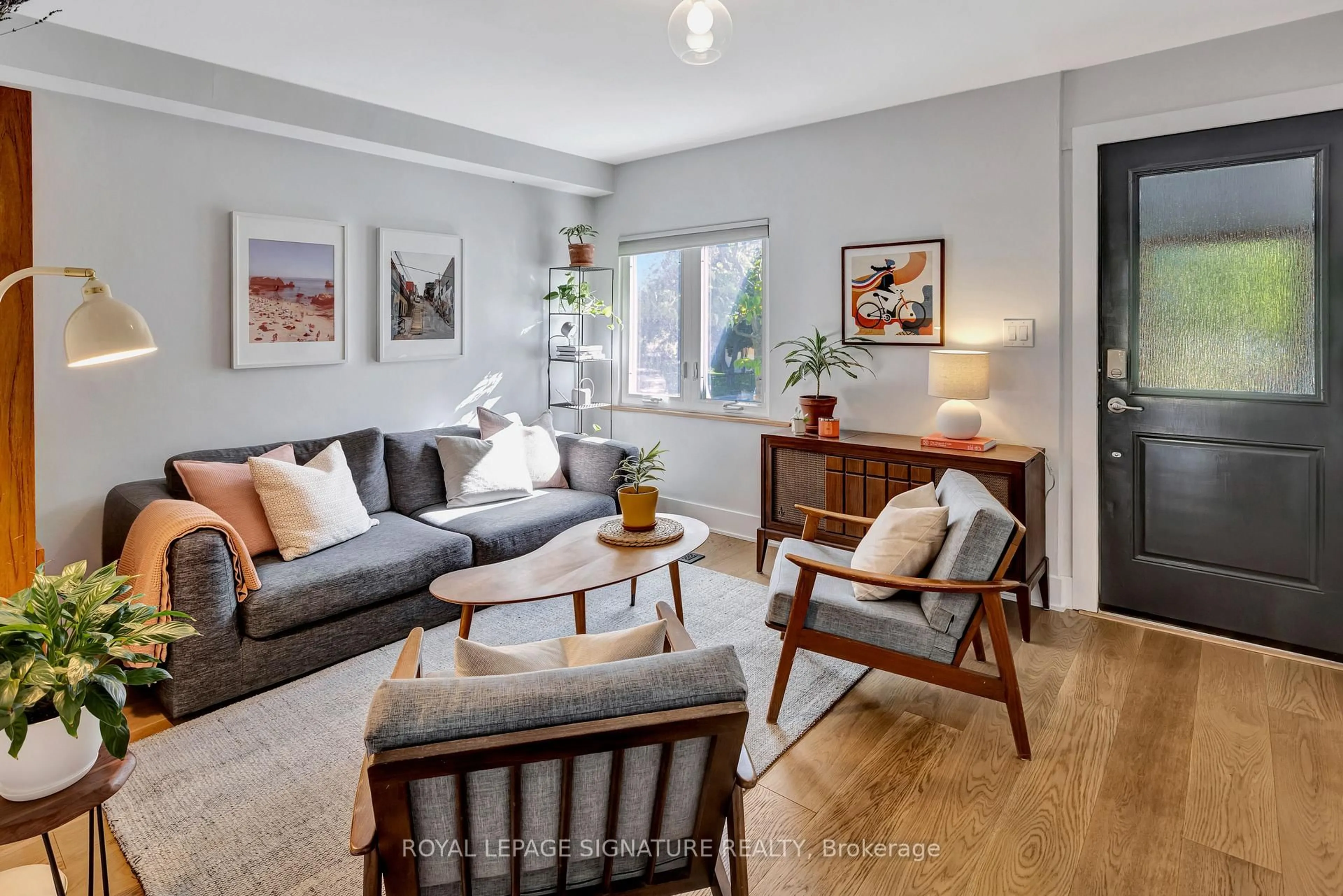 Living room with furniture, wood/laminate floor for 190 Alton Ave, Toronto Ontario M4L 2M5