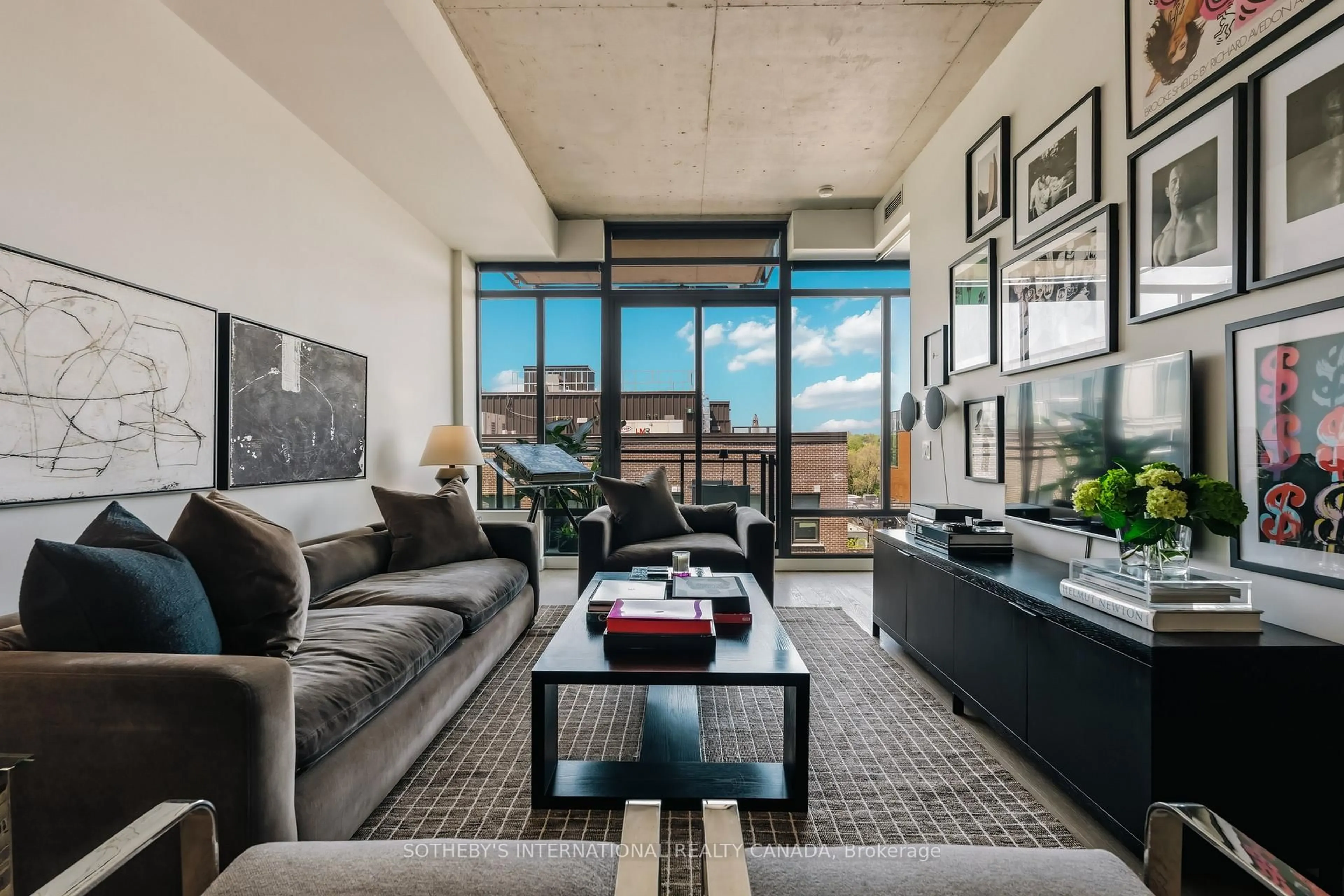 Living room with furniture, cement floor for 90 Broadview Ave #629, Toronto Ontario M4M 0A7