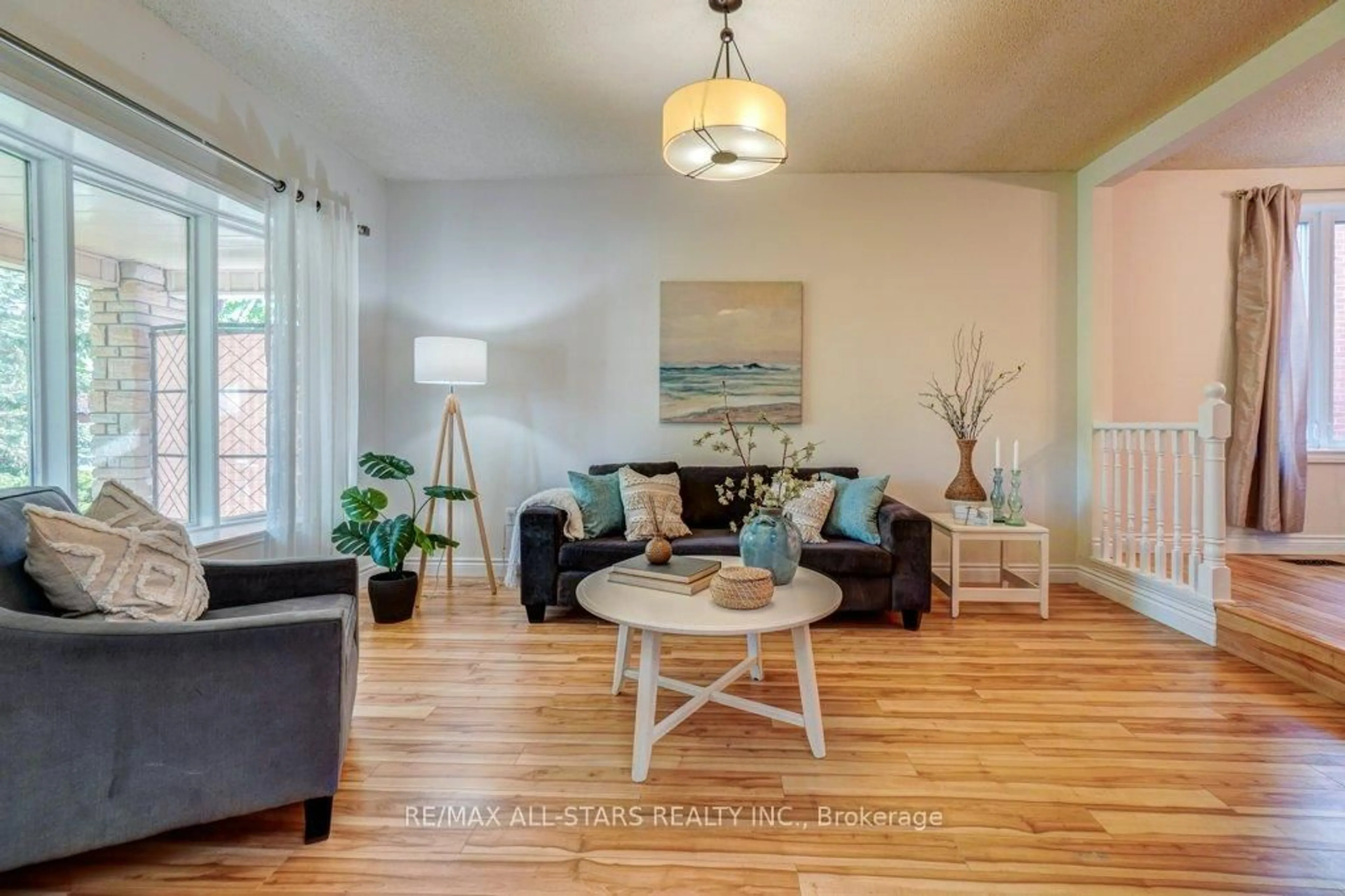 Living room with furniture, wood/laminate floor for 75 Hawley Cres, Whitby Ontario L1N 6X6