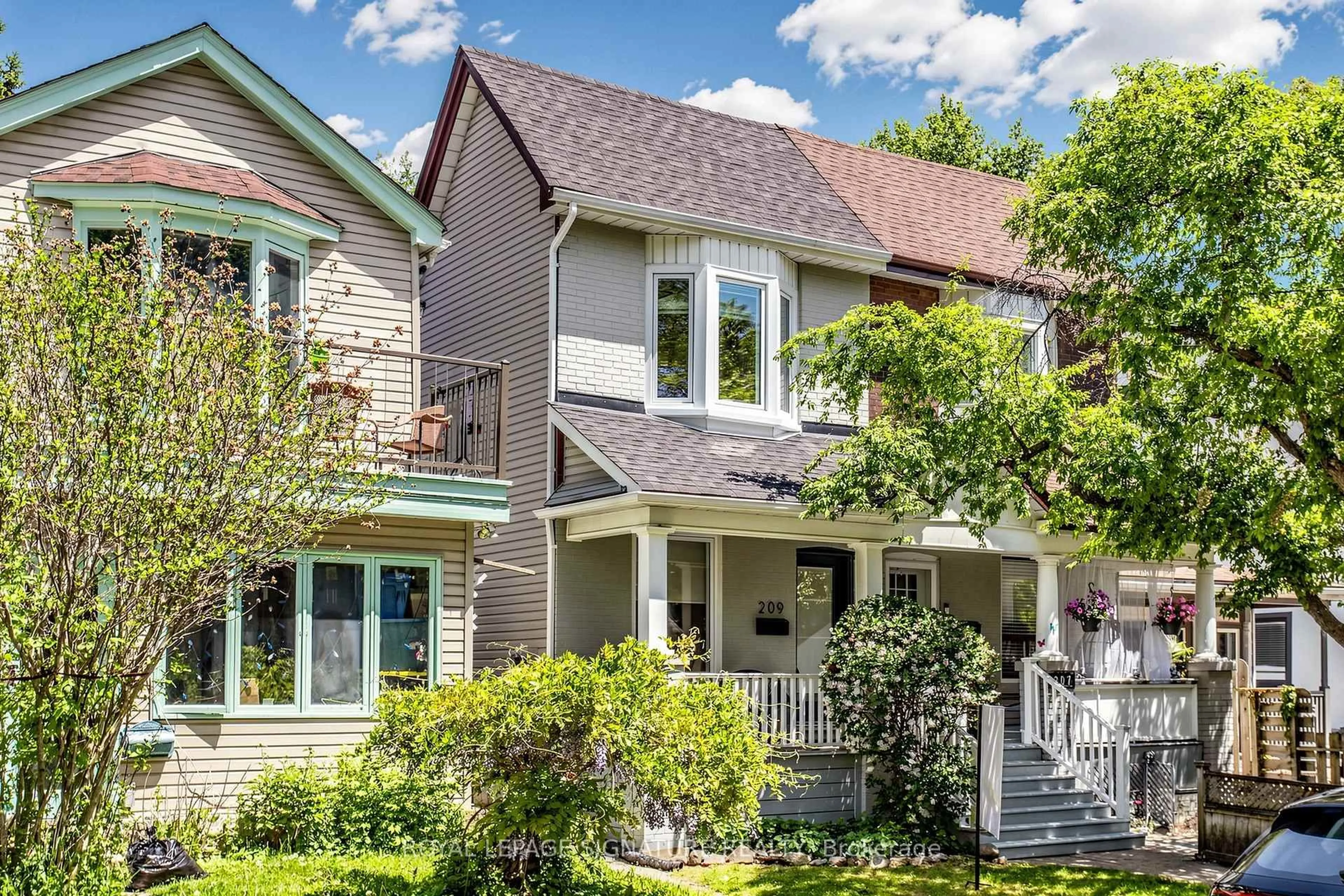 Home with vinyl exterior material, street for 209 Rhodes Ave, Toronto Ontario M4L 3A2