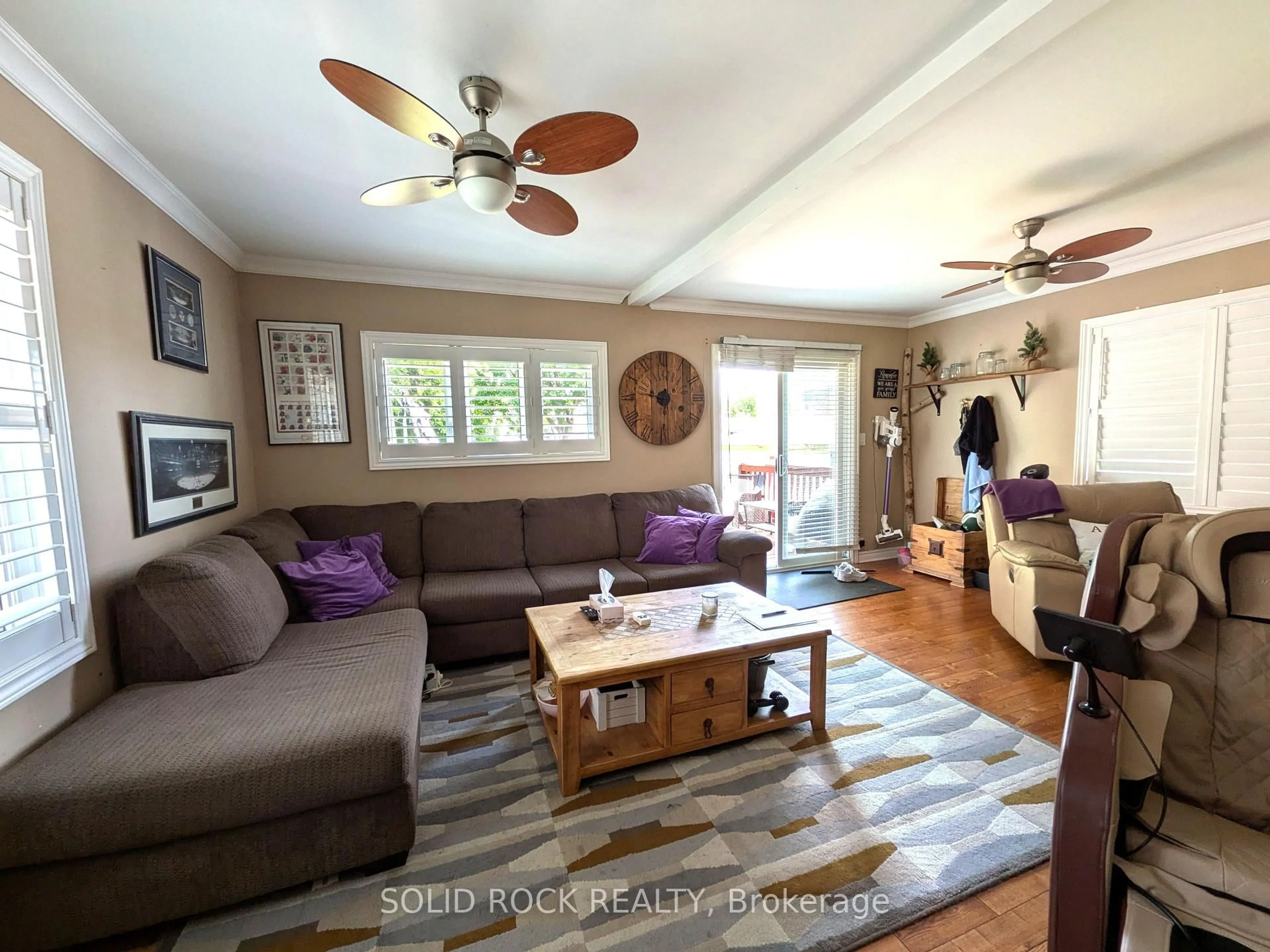 Living room with furniture, wood/laminate floor for 68 Cree Ave, Toronto Ontario M1M 1Z6
