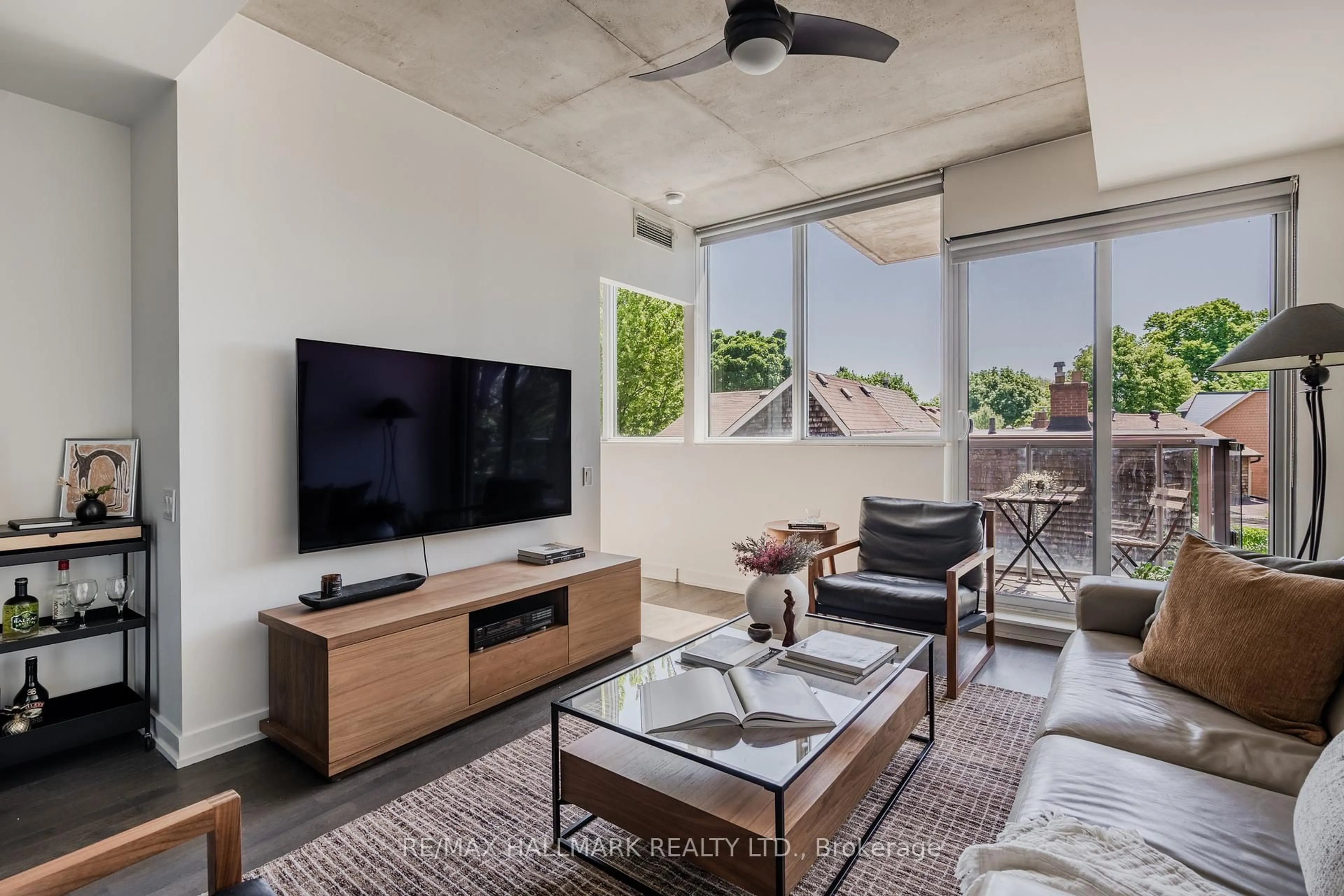 Living room with furniture, cement floor for 60 Haslett Ave #201, Toronto Ontario M4L 0A9