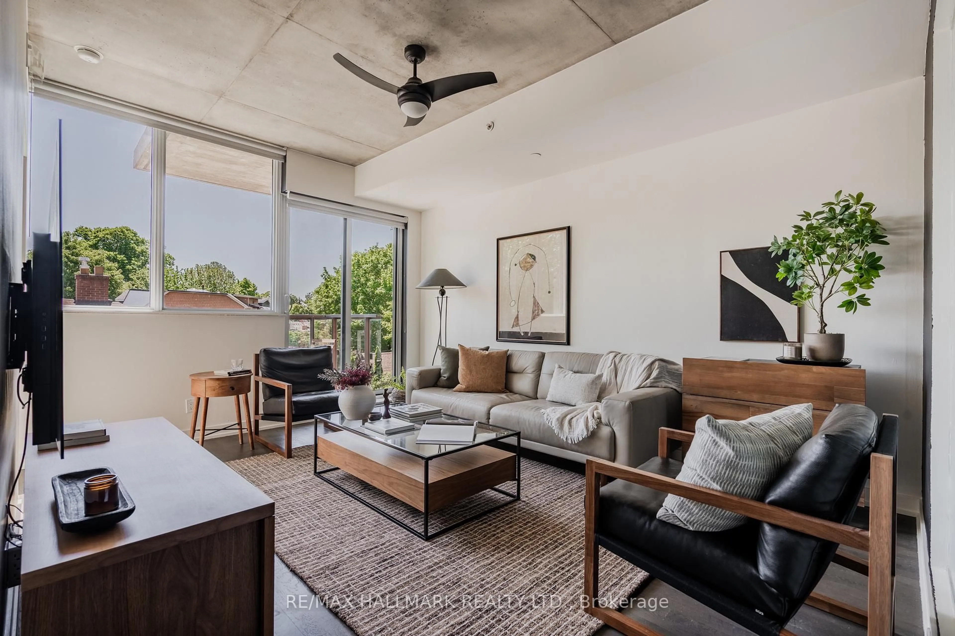 Living room with furniture, cement floor for 60 Haslett Ave #201, Toronto Ontario M4L 0A9