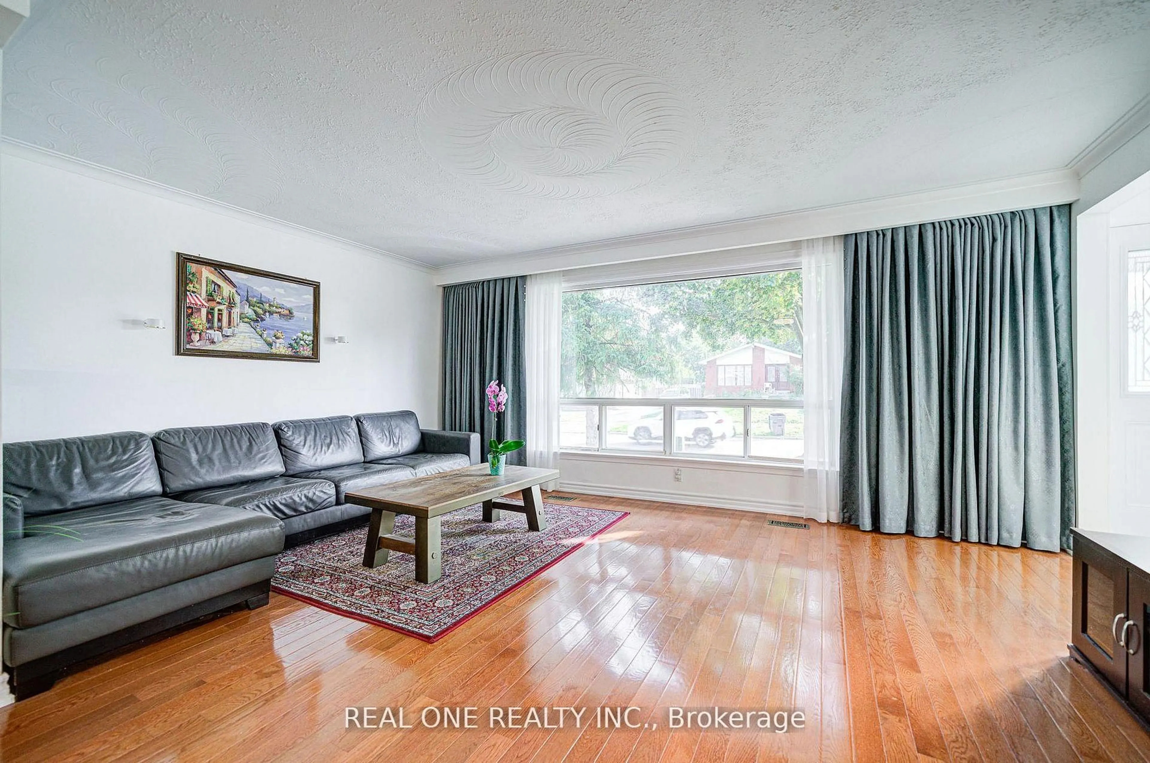 Living room with furniture, wood/laminate floor for 122 Marilake Dr, Toronto Ontario M1S 1V9