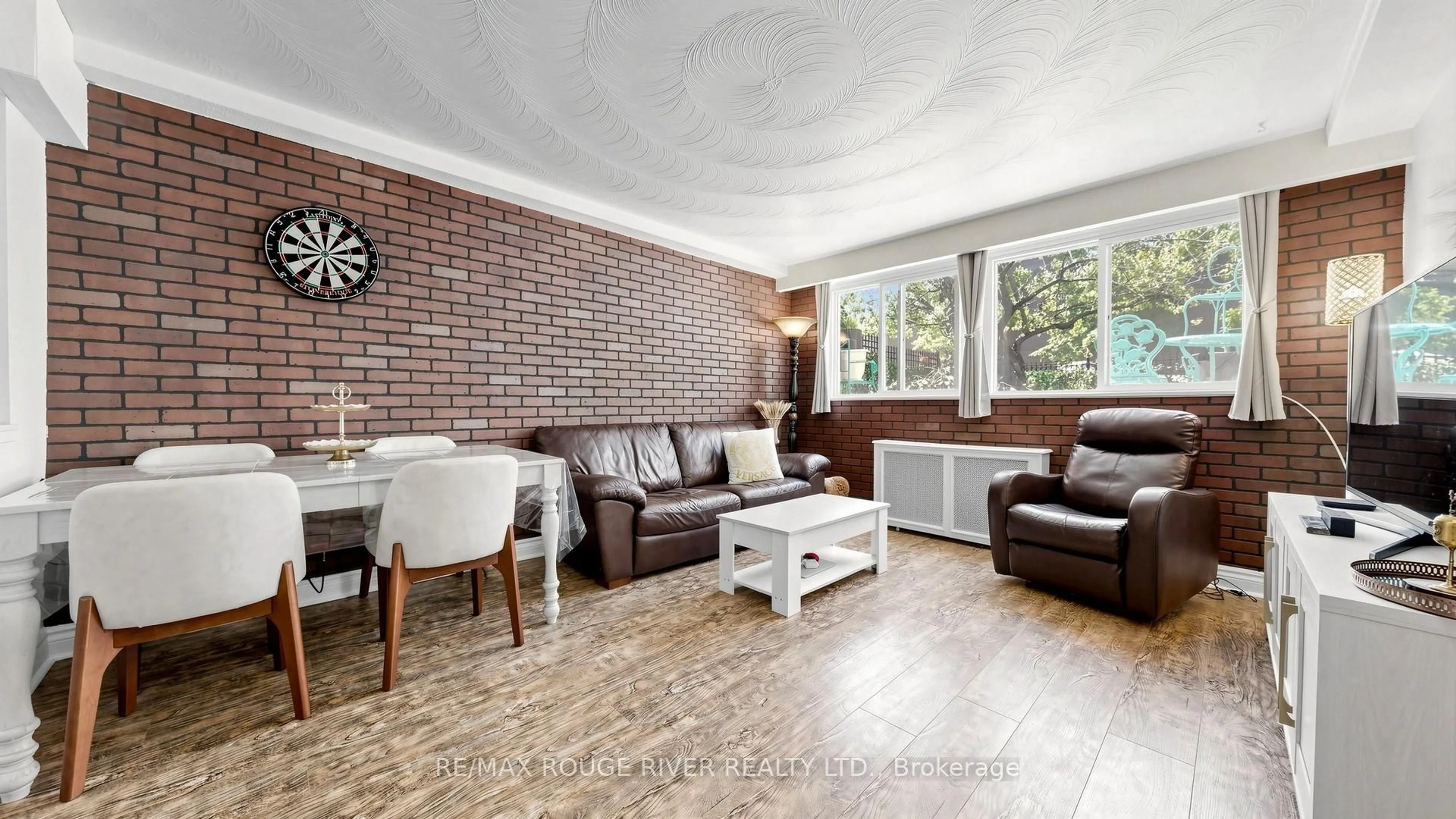 Living room with furniture, wood/laminate floor for 263 Oak Park Ave, Toronto Ontario M4C 4N4