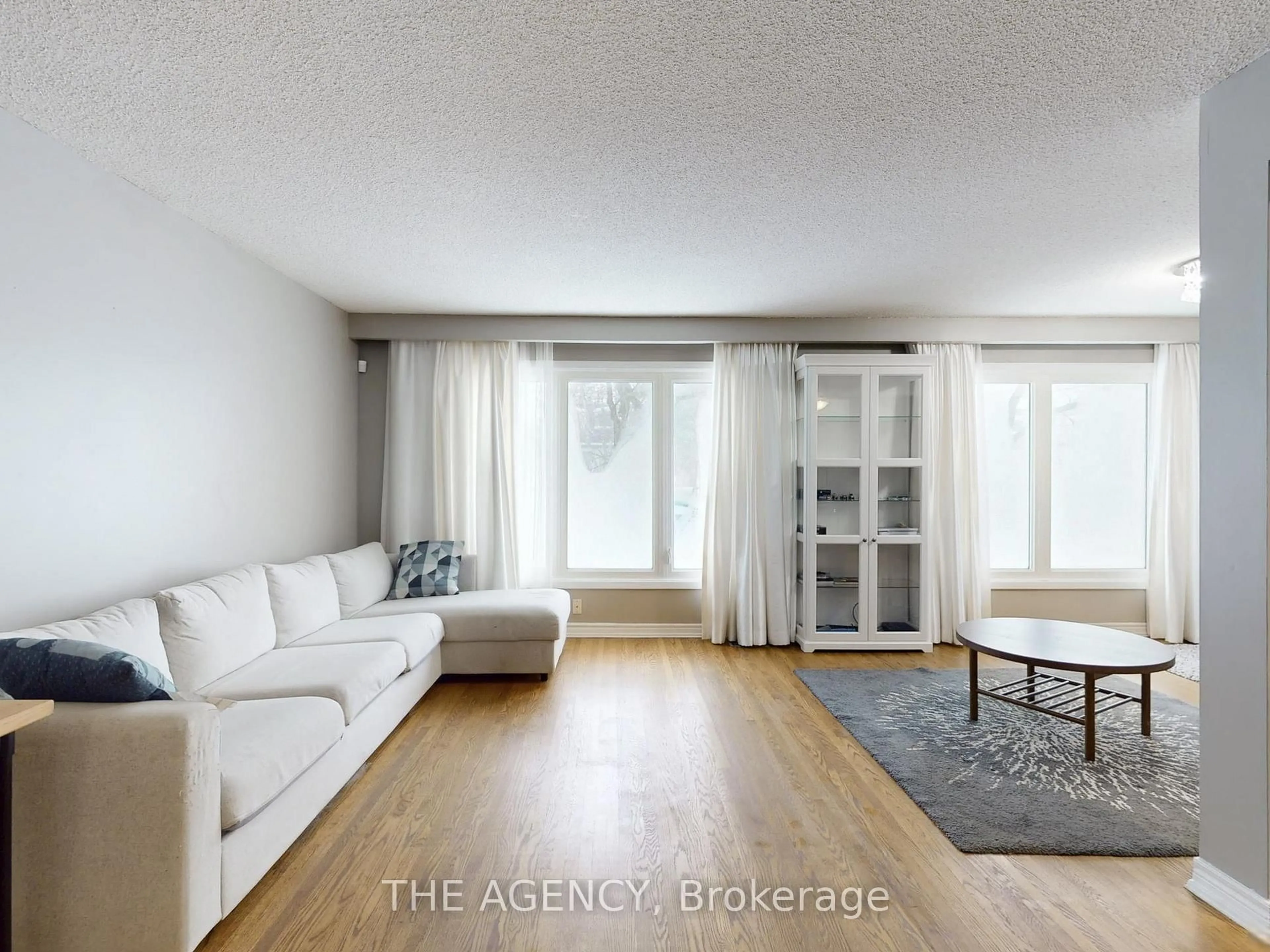 Living room with furniture, wood/laminate floor for 54 Manorglen Cres, Toronto Ontario M1S 1W4