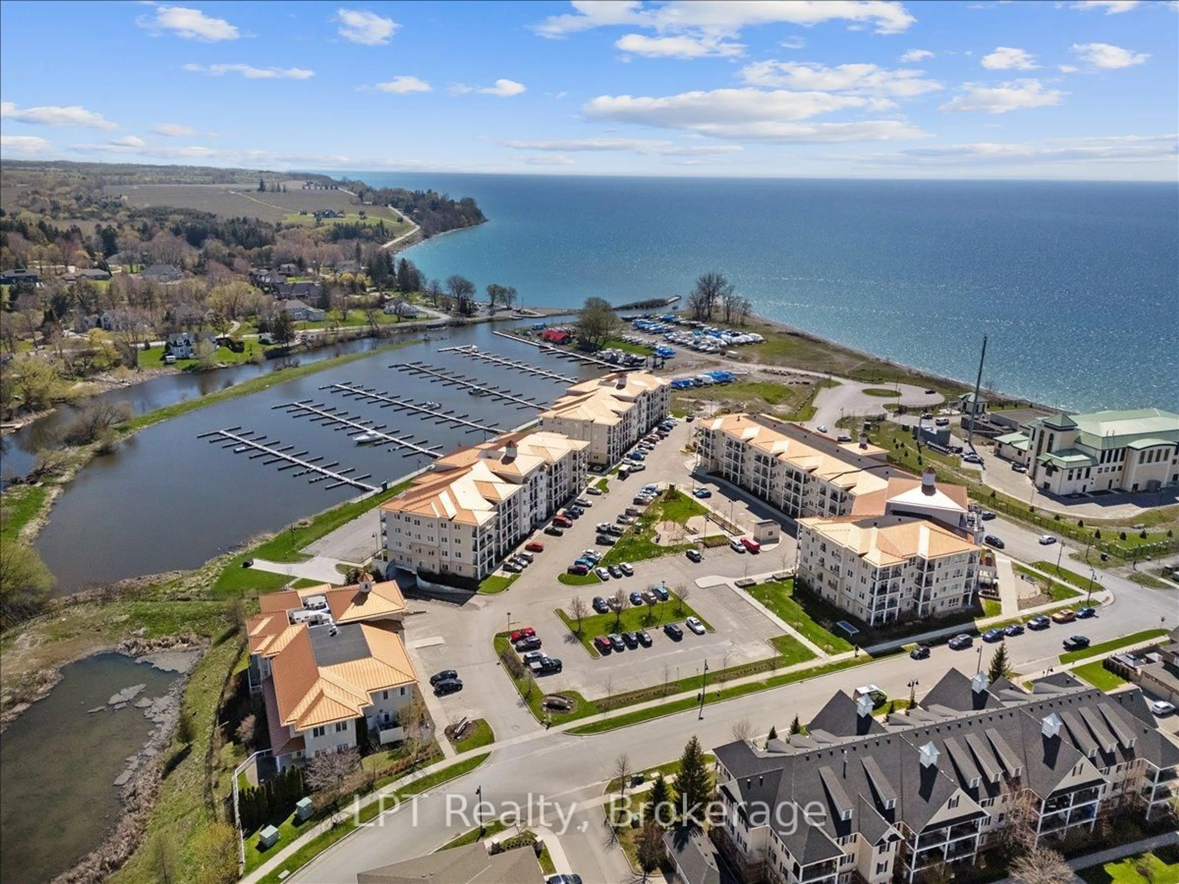 A pic from outside/outdoor area/front of a property/back of a property/a pic from drone, water/lake/river/ocean view for 50 Lakebreeze Dr #102, Clarington Ontario L1B 0V9