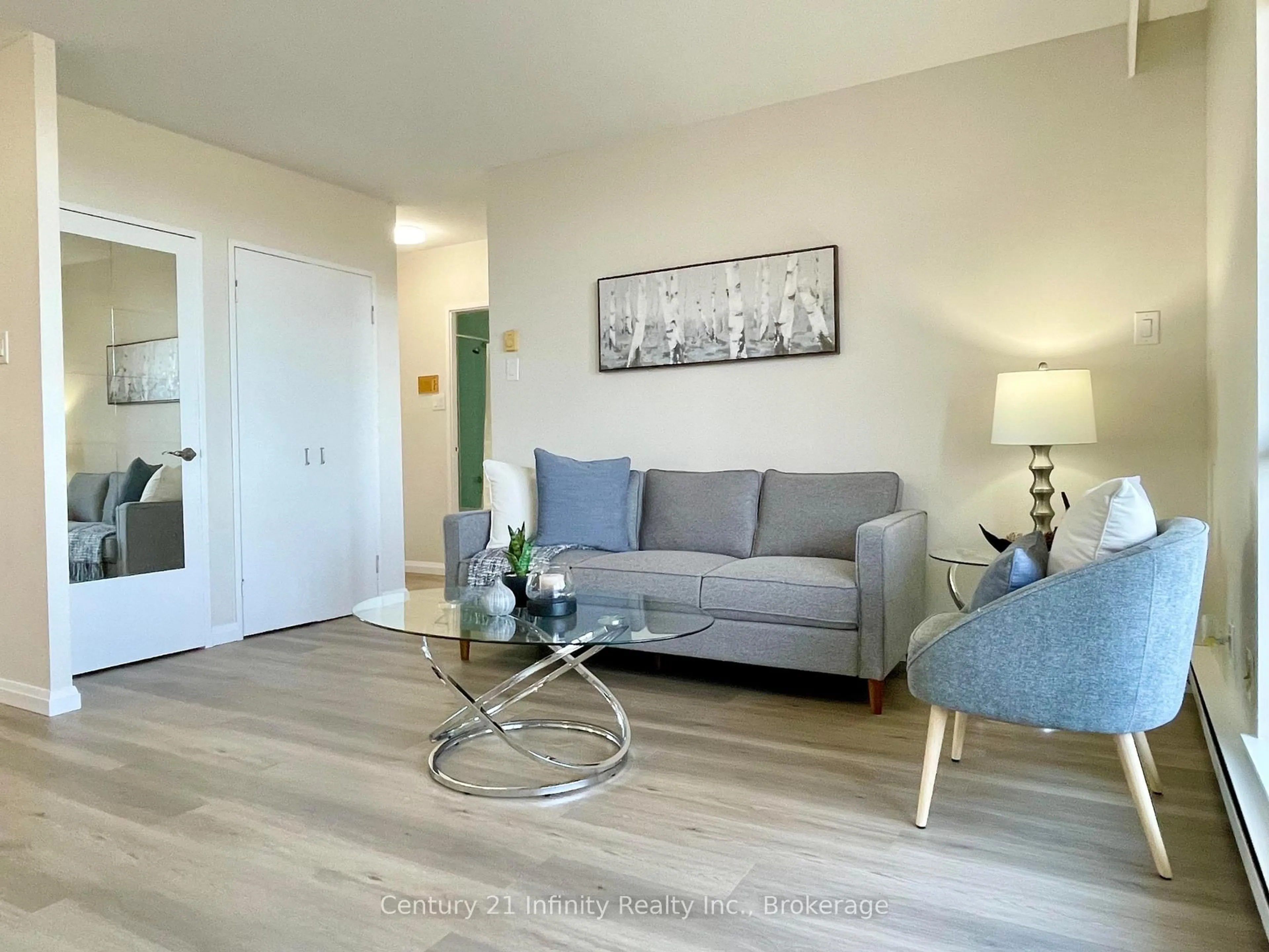 Living room with furniture, wood/laminate floor for 50 Old Kingston Rd #5-606, Toronto Ontario M1E 4Y1