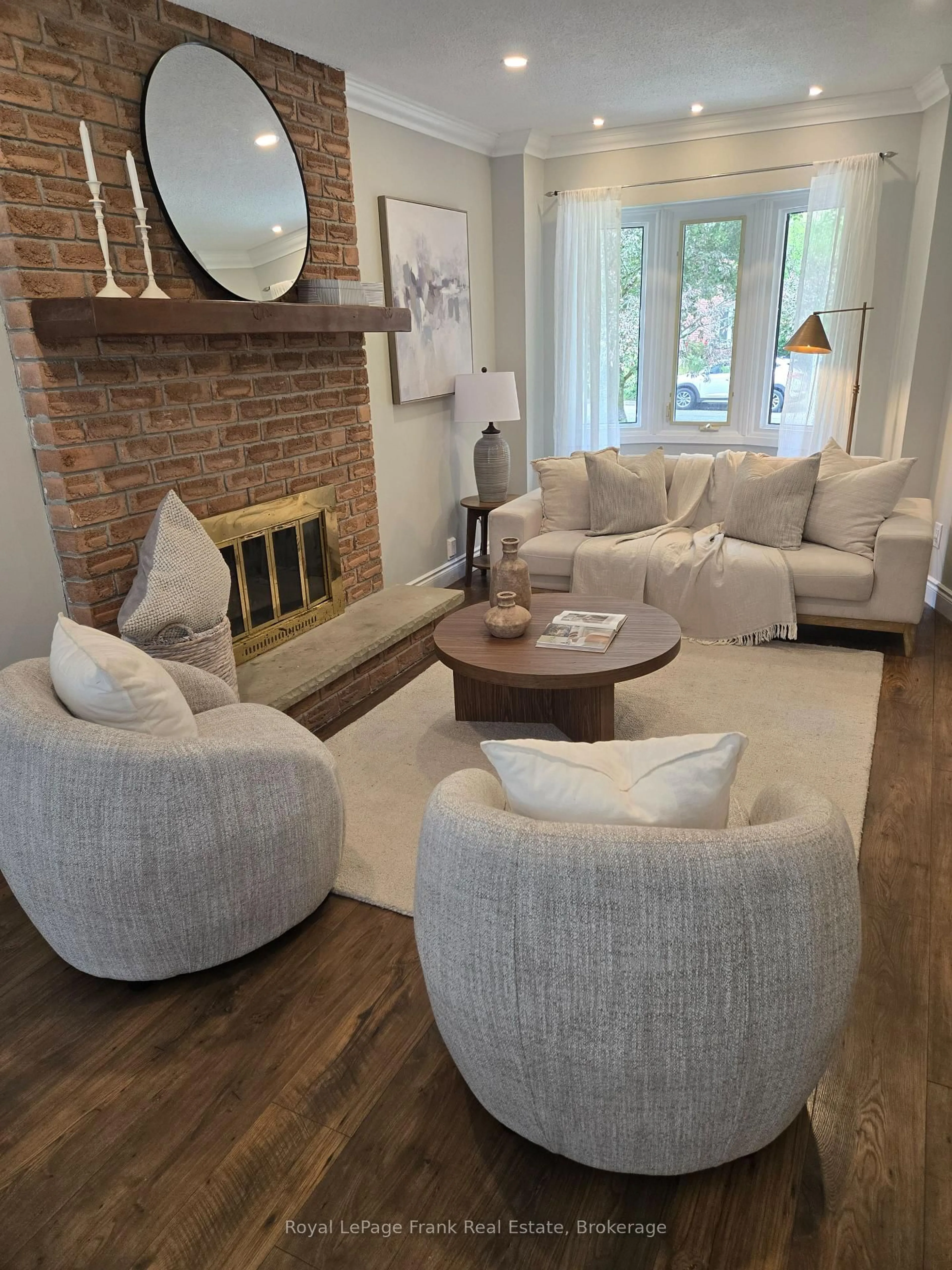 Living room with furniture, wood/laminate floor for 731 Honey Tree Crt, Whitby Ontario L1N 7W5