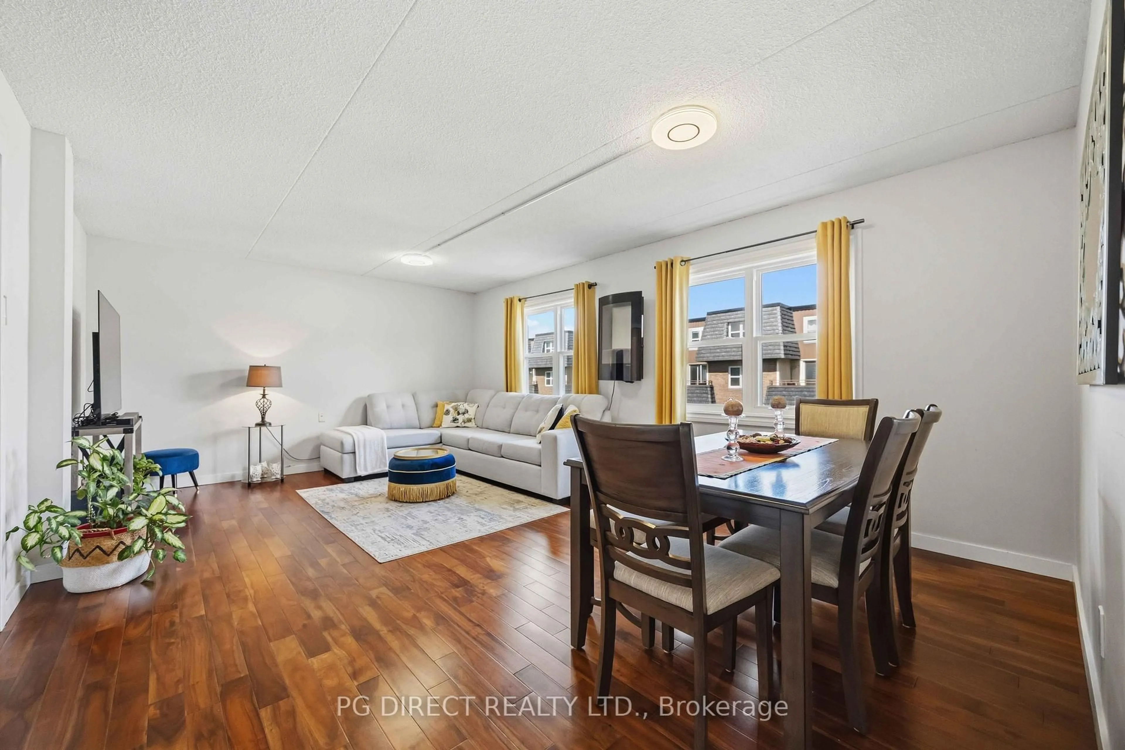 Living room with furniture, wood/laminate floor for 580 Mary St #214, Whitby Ontario L1N 2R3
