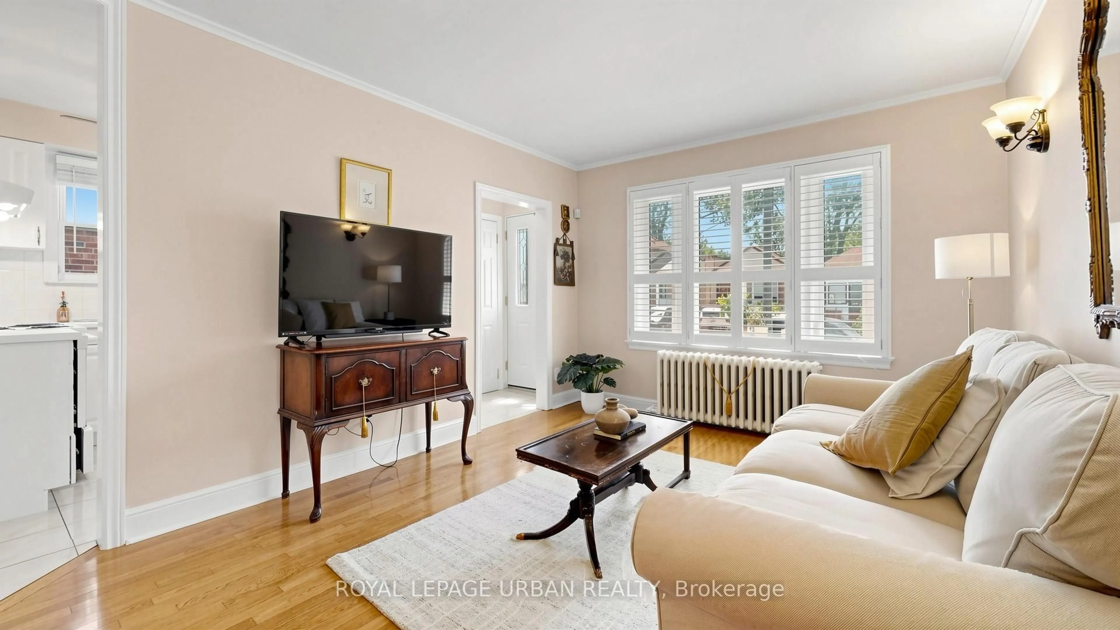 Living room with furniture, wood/laminate floor for 202 Virginia Ave, Toronto Ontario M4C 2T7