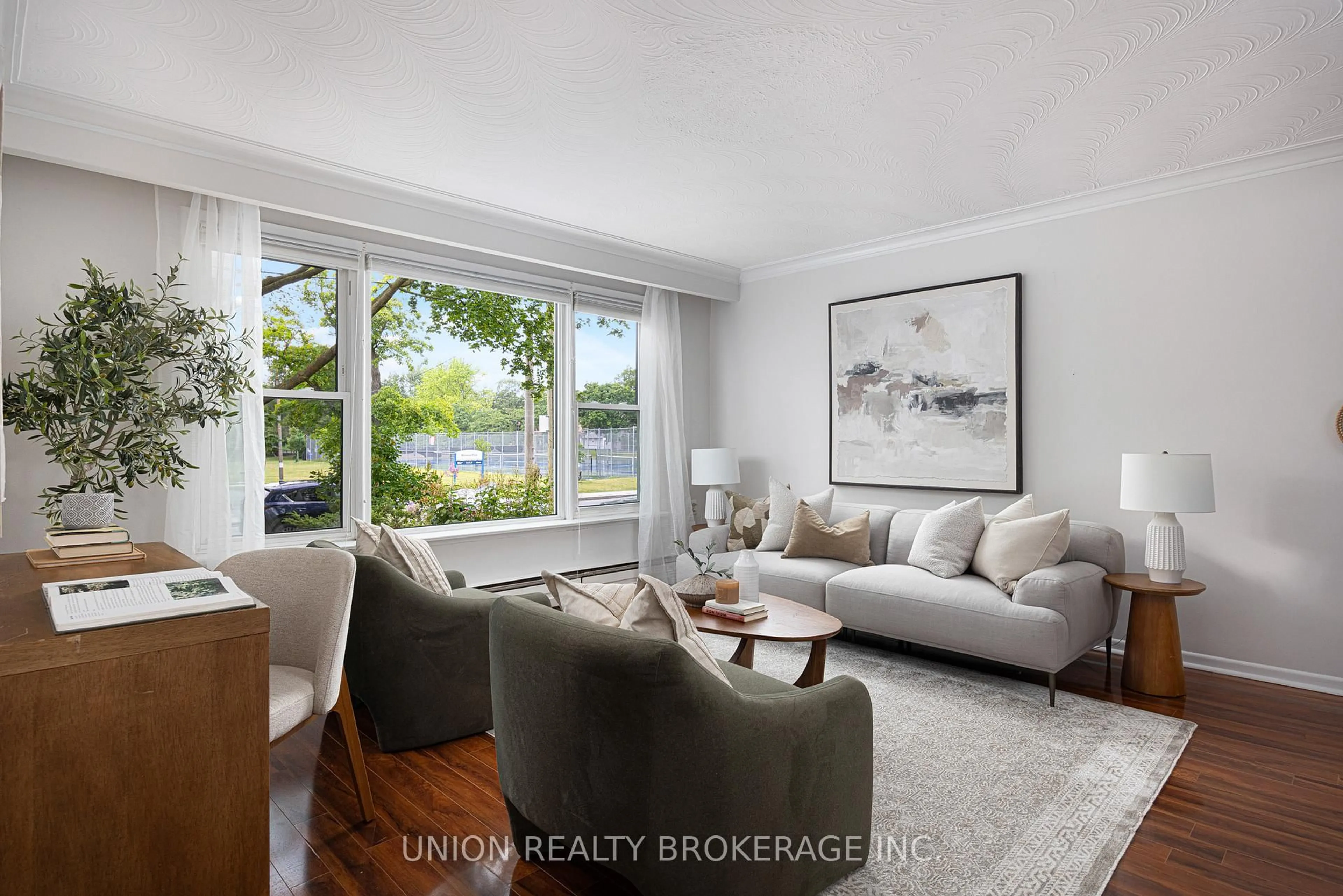 Living room with furniture, wood/laminate floor for 7 Norwood Rd, Toronto Ontario M4E 2R9