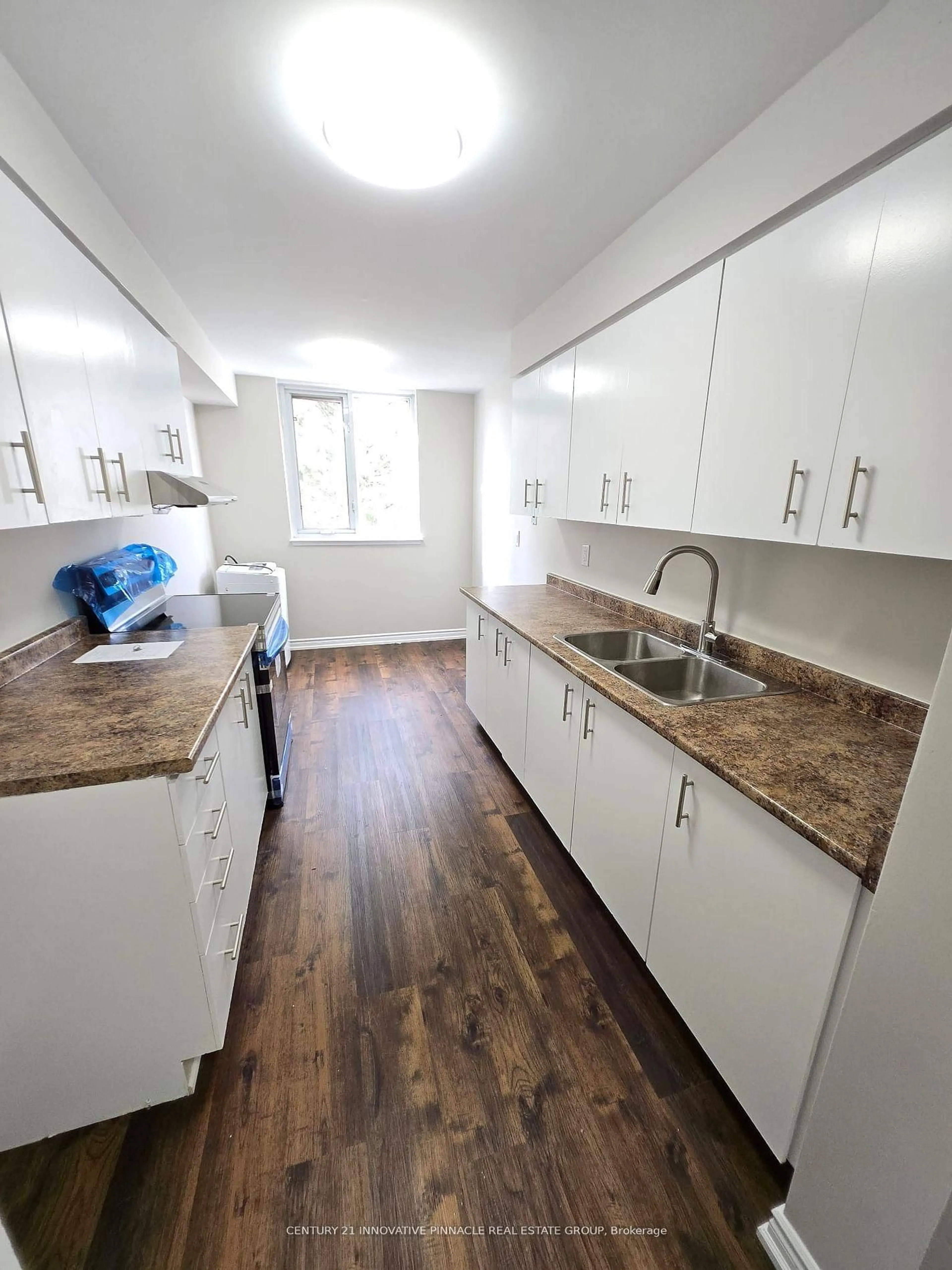 Standard kitchen, wood/laminate floor for 15 Sewells Rd #402, Toronto Ontario M1B 3J7