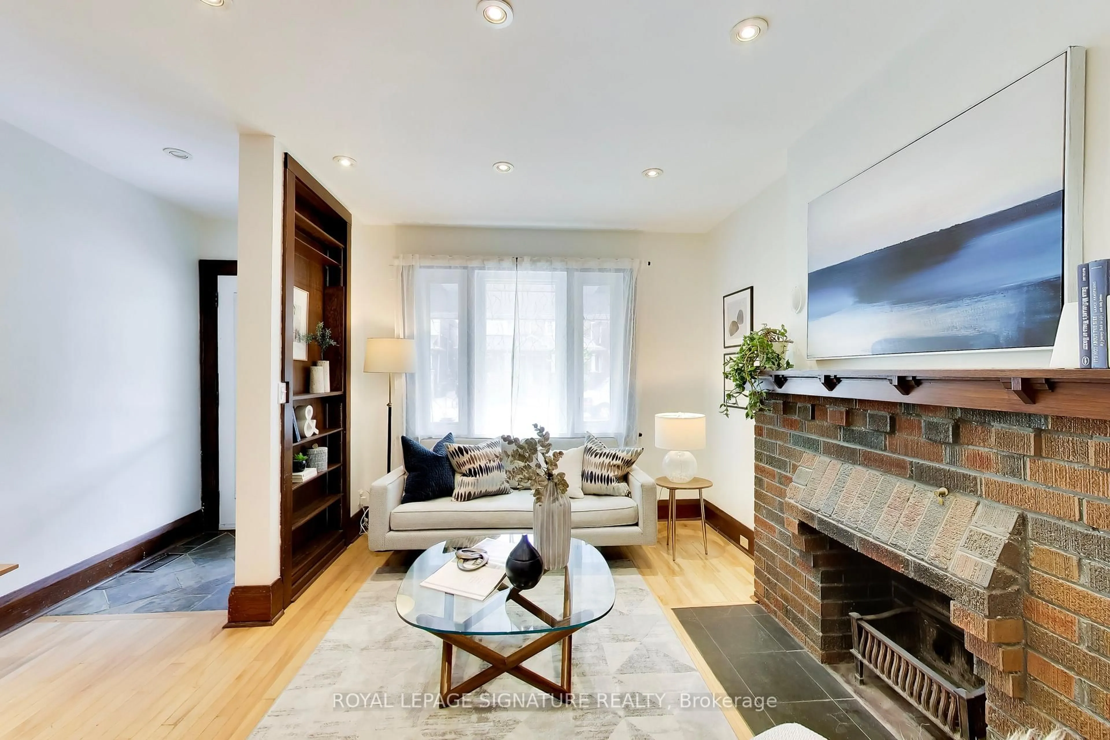 Living room with furniture, wood/laminate floor for 2102 Gerrard St, Toronto Ontario M4E 2B8