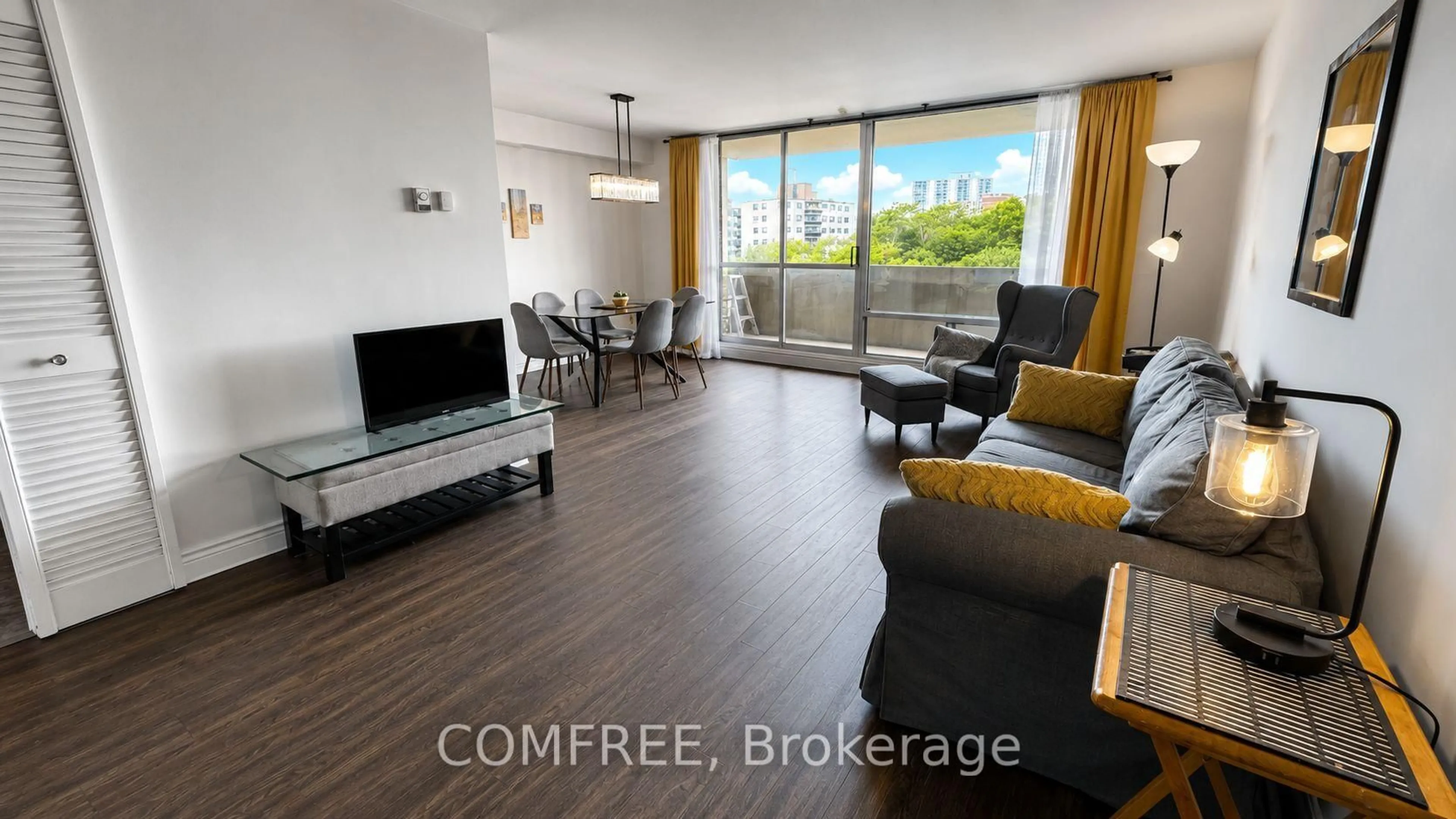 Living room with furniture, wood/laminate floor for 1 Massey Sq #412, Toronto Ontario M4C 5L4