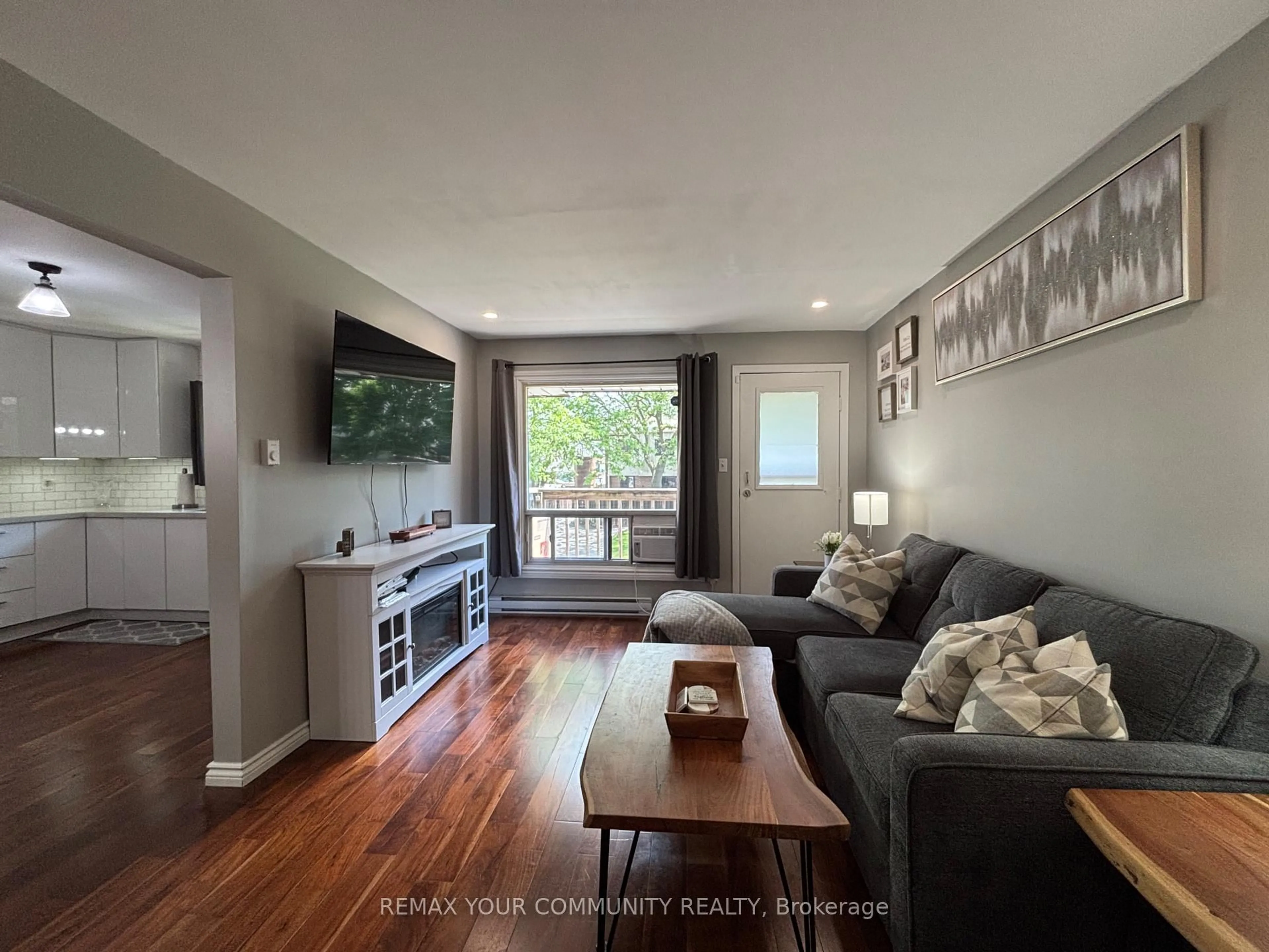 Living room with furniture, wood/laminate floor for 1100 Oxford St #74, Oshawa Ontario L1J 6G4