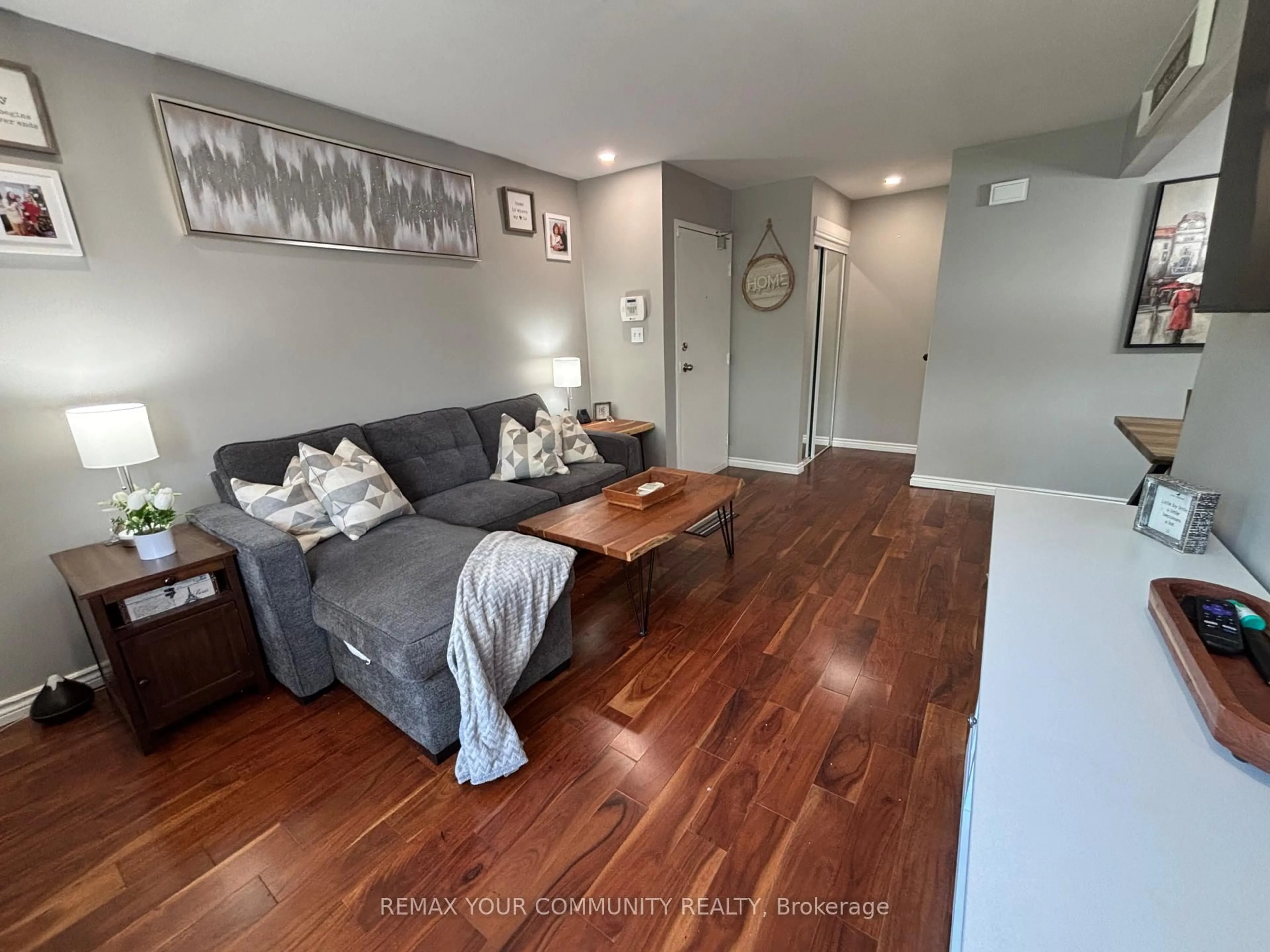 Living room with furniture, wood/laminate floor for 1100 Oxford St #74, Oshawa Ontario L1J 6G4