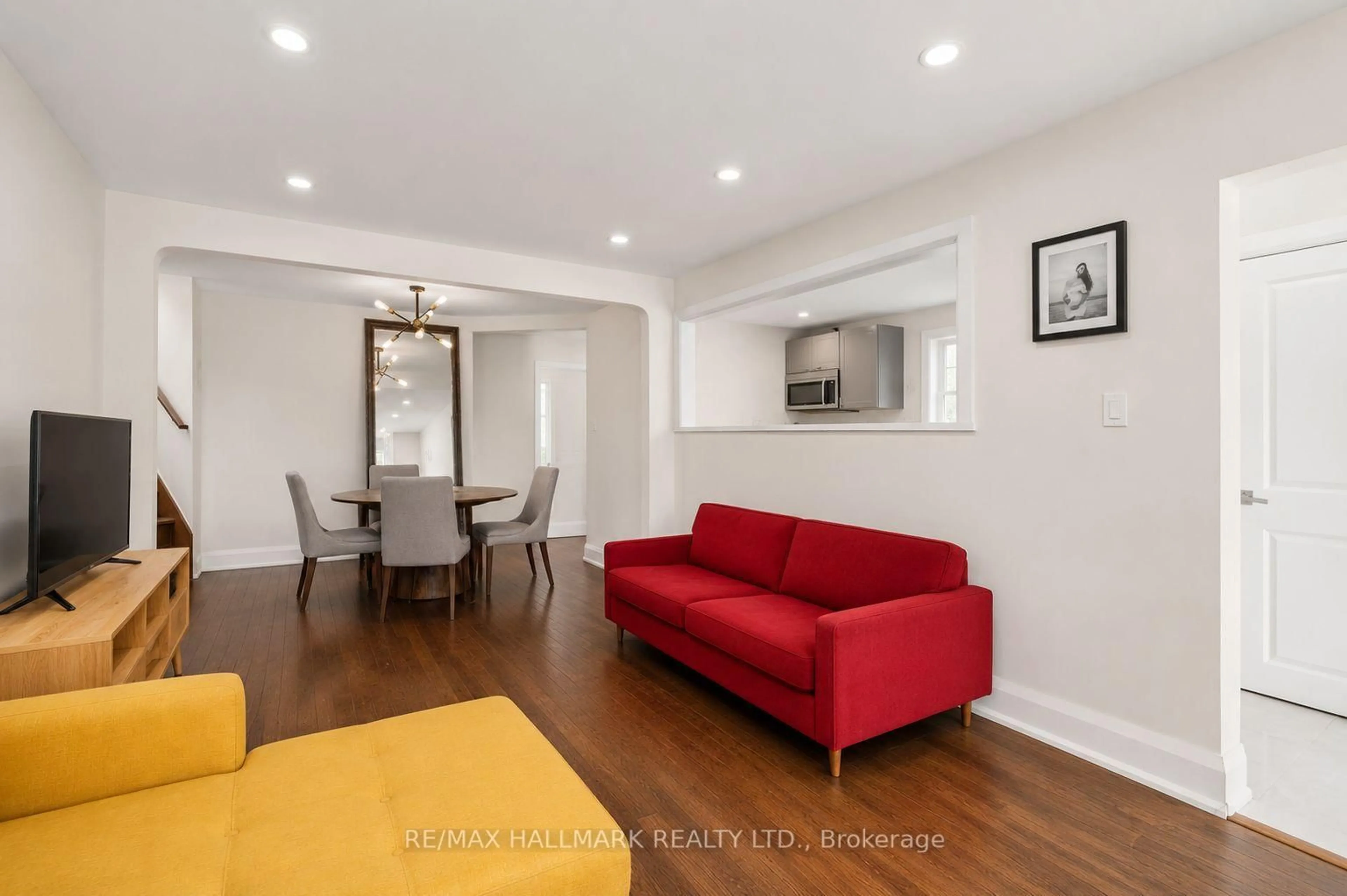 Living room with furniture, wood/laminate floor for 8 Davies Cres, Toronto Ontario M4J 2X5