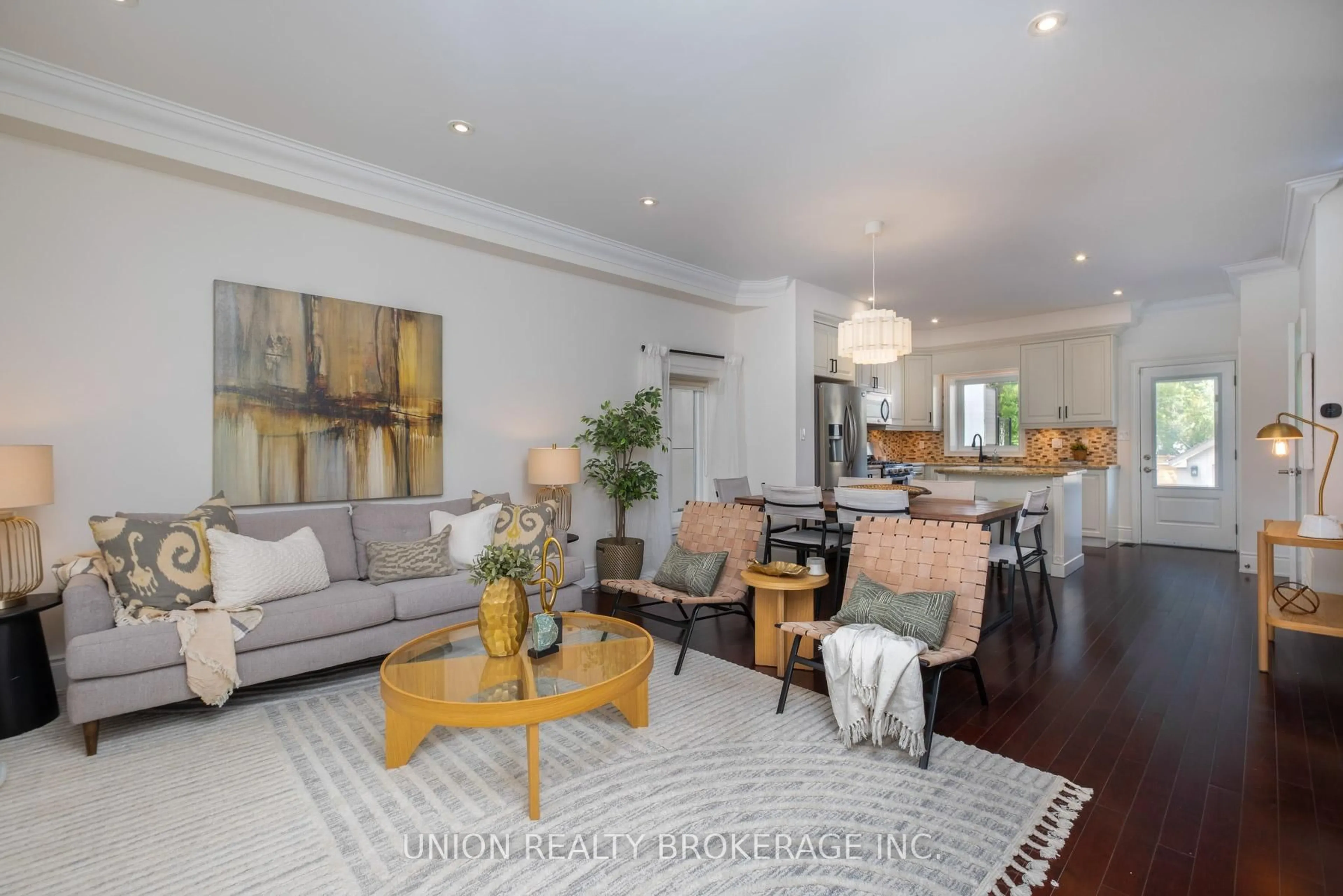 Living room with furniture, wood/laminate floor for 174 Woodmount Ave, Toronto Ontario M4C 3Z2