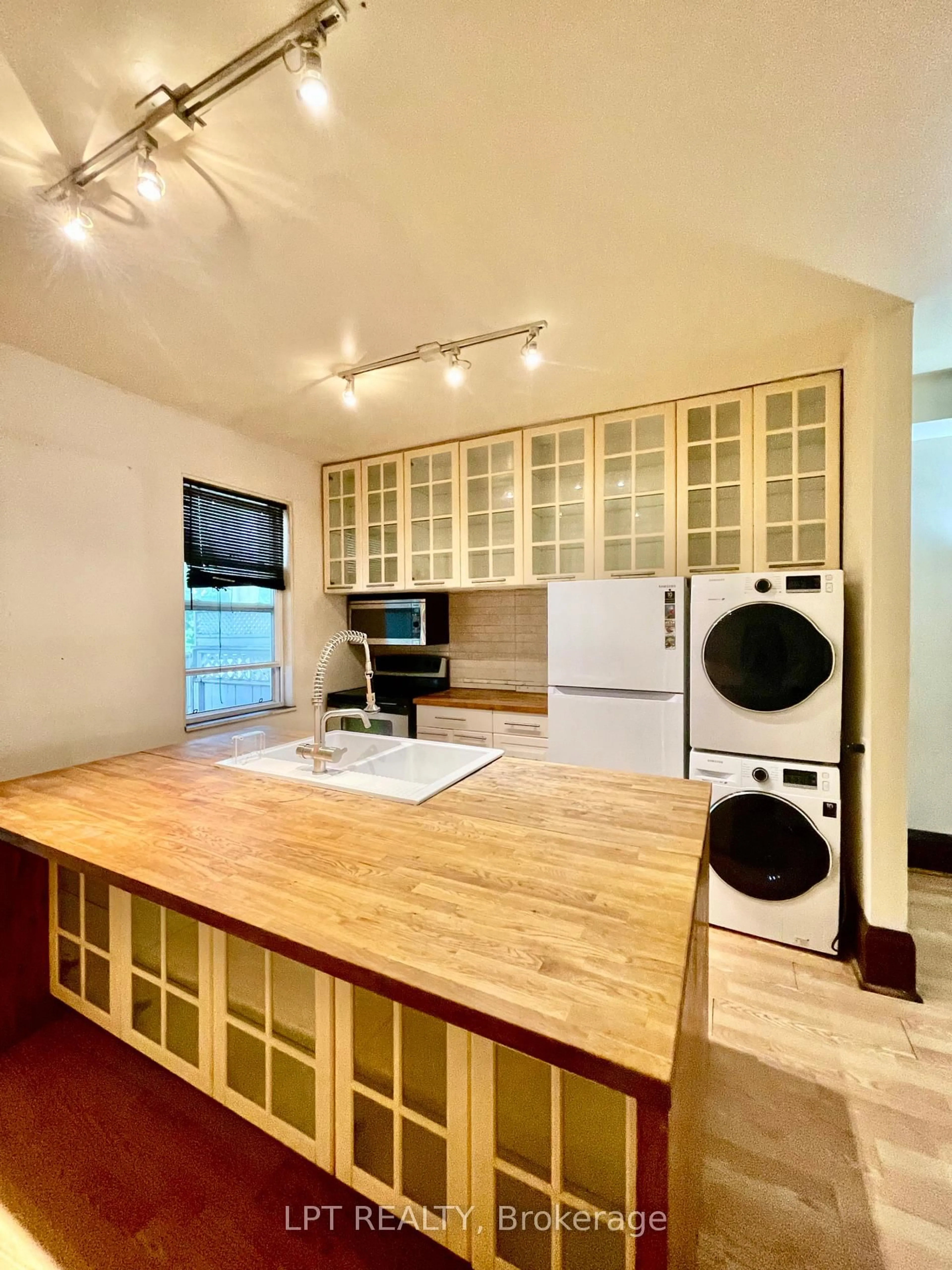 Kitchen with laundary machines, unknown for 326 Beech Ave, Toronto Ontario M4E 3J3