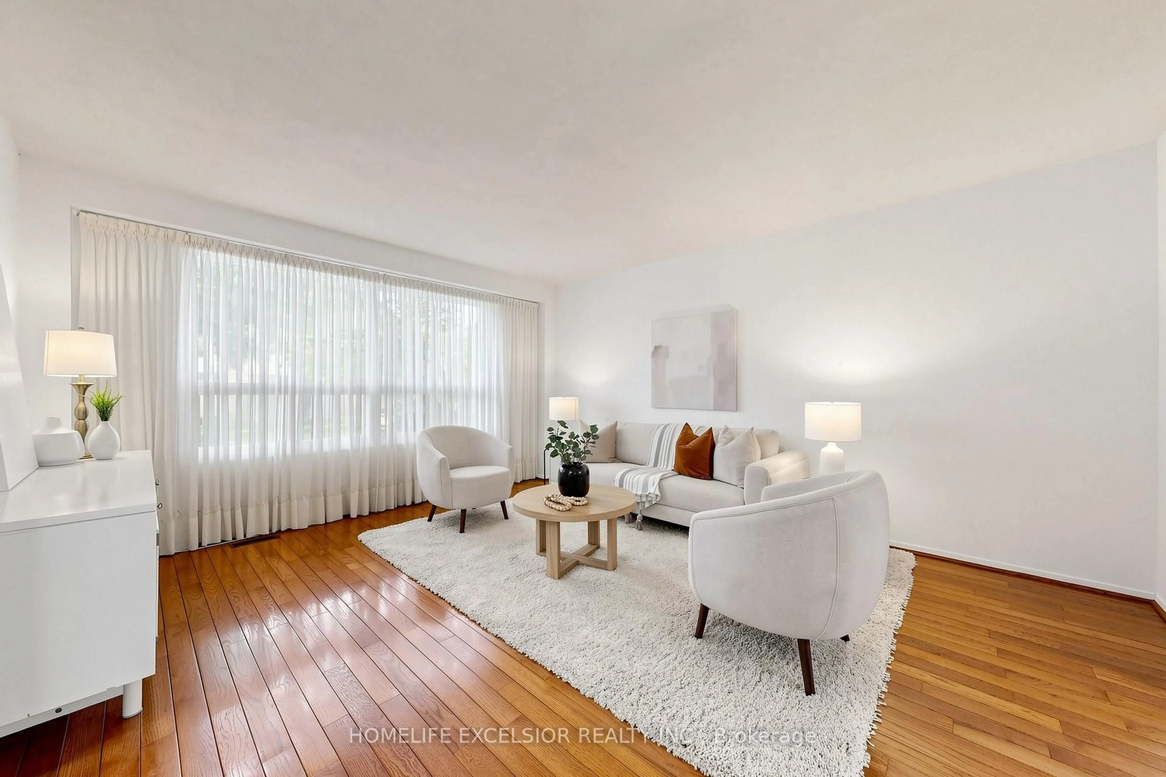 Living room with furniture, wood/laminate floor for 8 Dunmail Dr, Toronto Ontario M1V 1J5